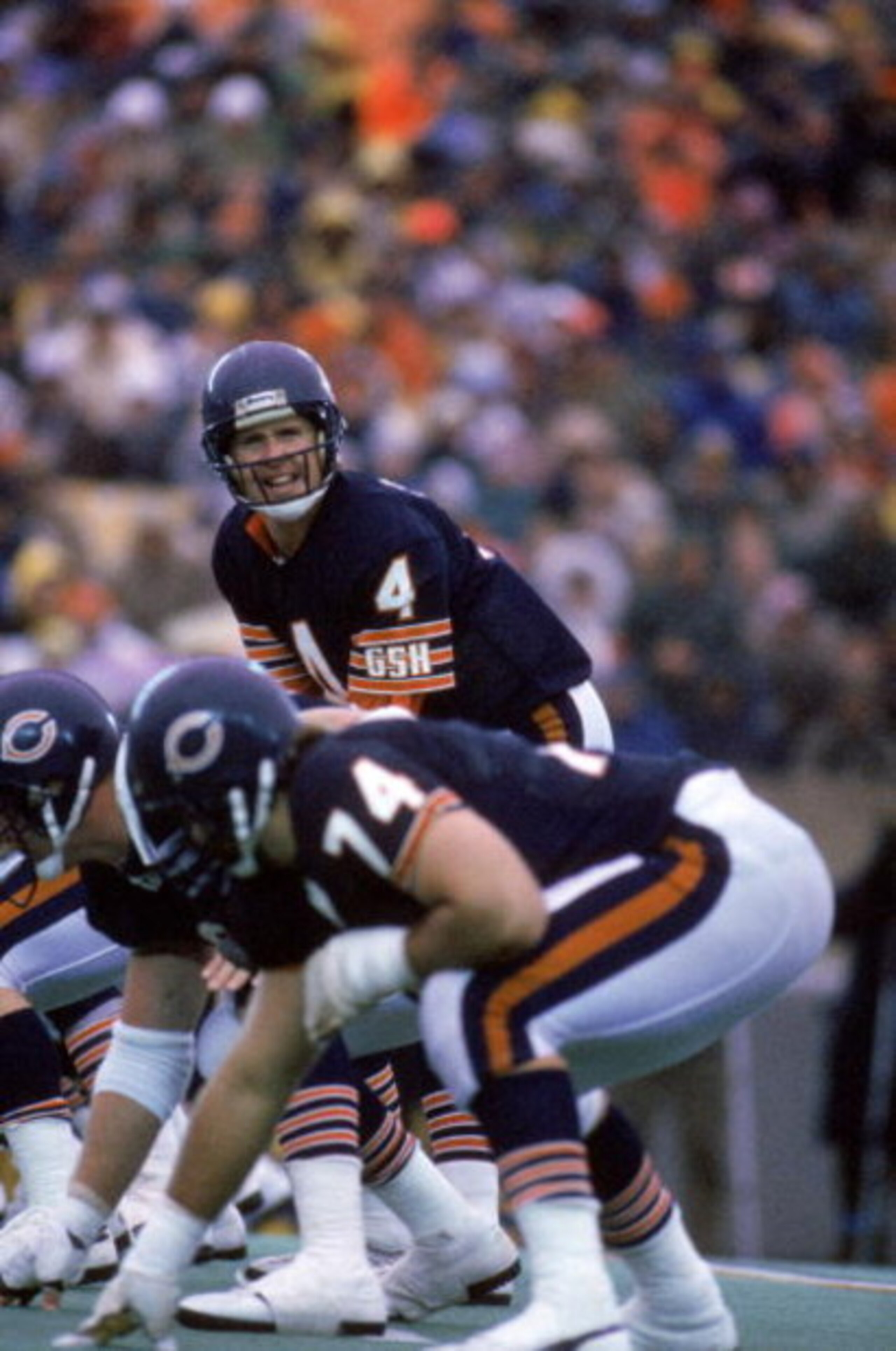 CHICAGO - 1985:  Quarterback Steve Fuller #4 of the Chicago Bears calls a play at the line of scrimmage during a game against the Detroit Lions in 1985 at Soldier Field in Chicago, Illinois.  The Bears won 23-3.  (Photy by Mike Powell/Getty Images)