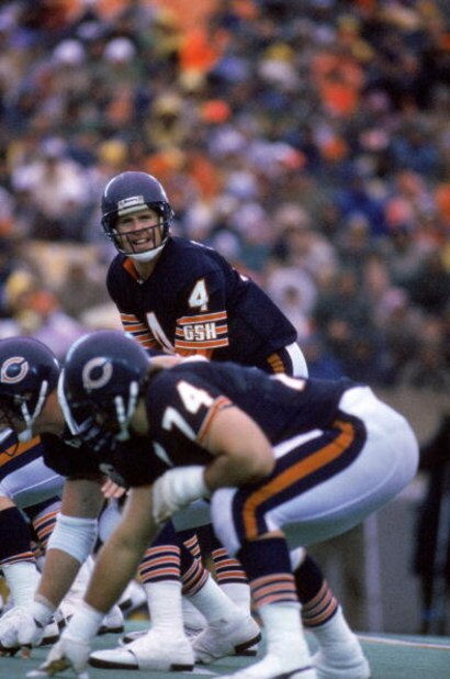 CHICAGO - 1985:  Quarterback Steve Fuller #4 of the Chicago Bears calls a play at the line of scrimmage during a game against the Detroit Lions in 1985 at Soldier Field in Chicago, Illinois.  The Bears won 23-3.  (Photy by Mike Powell/Getty Images)