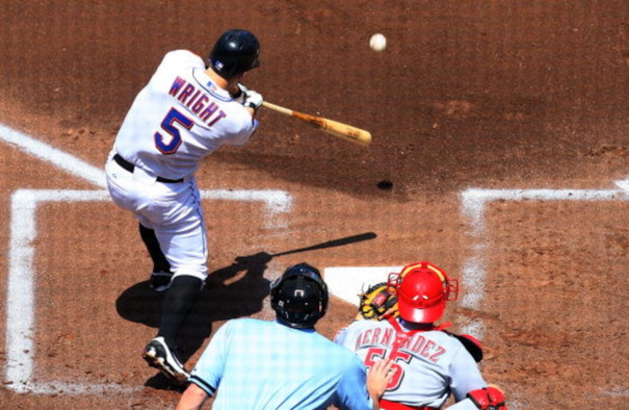NEW YORK - JULY 12: David Wright #5 of the New York Mets connects for a first inning RBI double against the Cincinnati Reds on July 12, 2009 at Citi Field in the Flushing neighborhood of the Queens borough of New York City.  (Photo by Jim McIsaac/Getty Im
