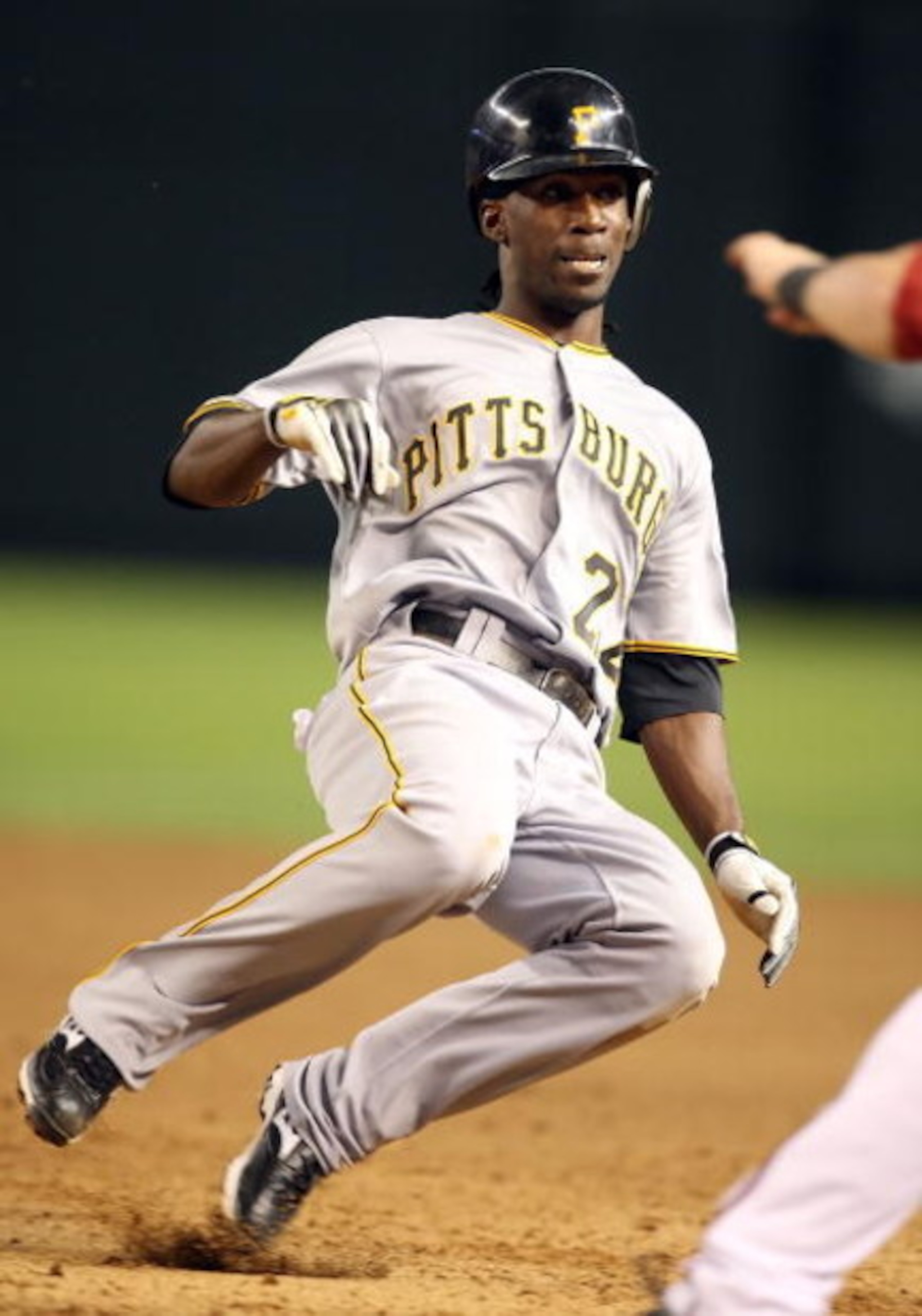 PHOENIX - JULY 23:  Andrew McCutchen #22 of the Pittsburgh Pirates slides back into first base during the major league baseball game against the Arizona Diamondbacks at Chase Field on July 23, 2009 in Phoenix, Arizona. The Diamondbacks defeated the Pirate