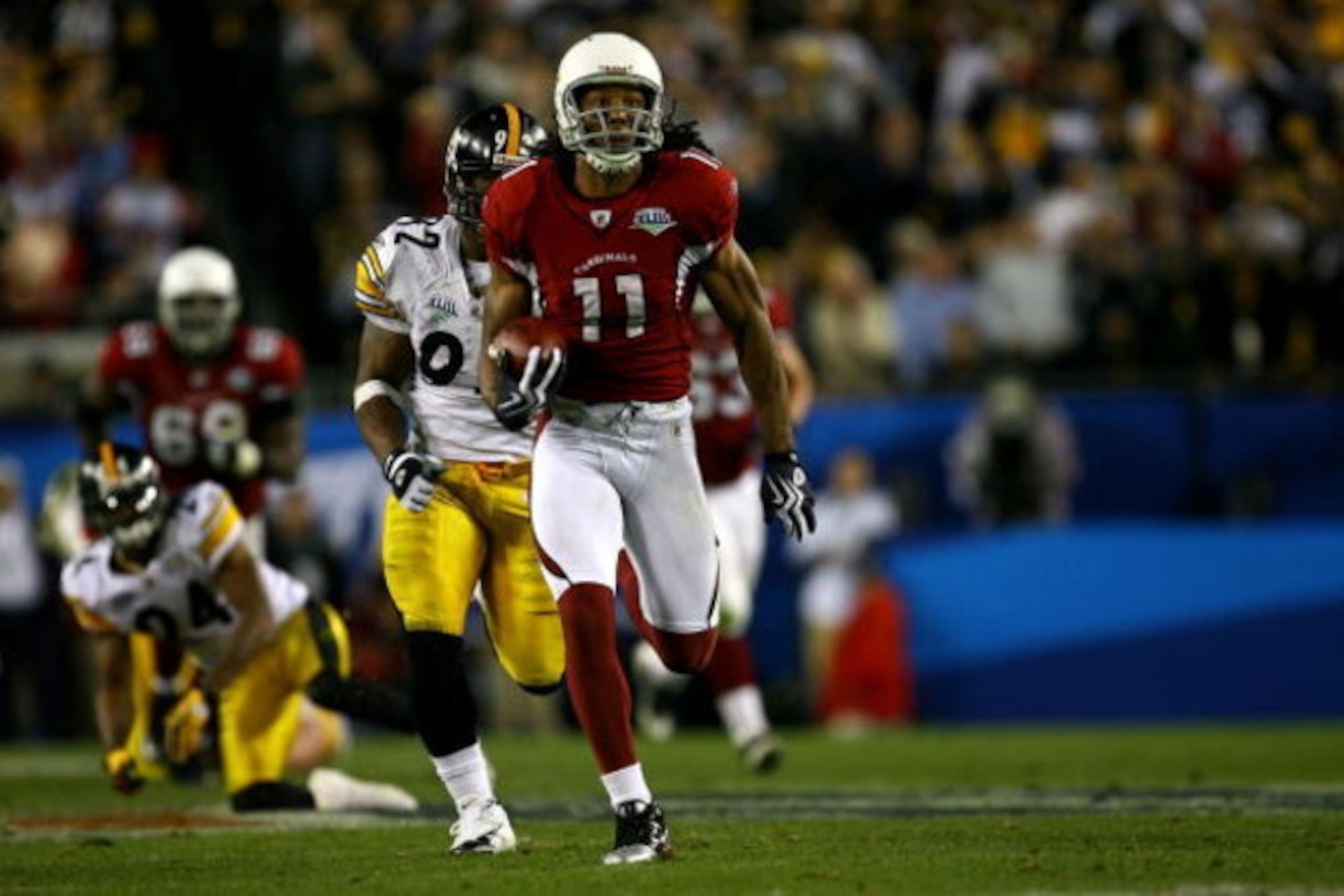TAMPA, FL - FEBRUARY 01:  Wide receiver Larry Fitzgerald #11 of the Arizona Cardinals scores a 64-yard touchdown reception in the fourth quarter against the Pittsburgh Steelers during Super Bowl XLIII on February 1, 2009 at Raymond James Stadium in Tampa,