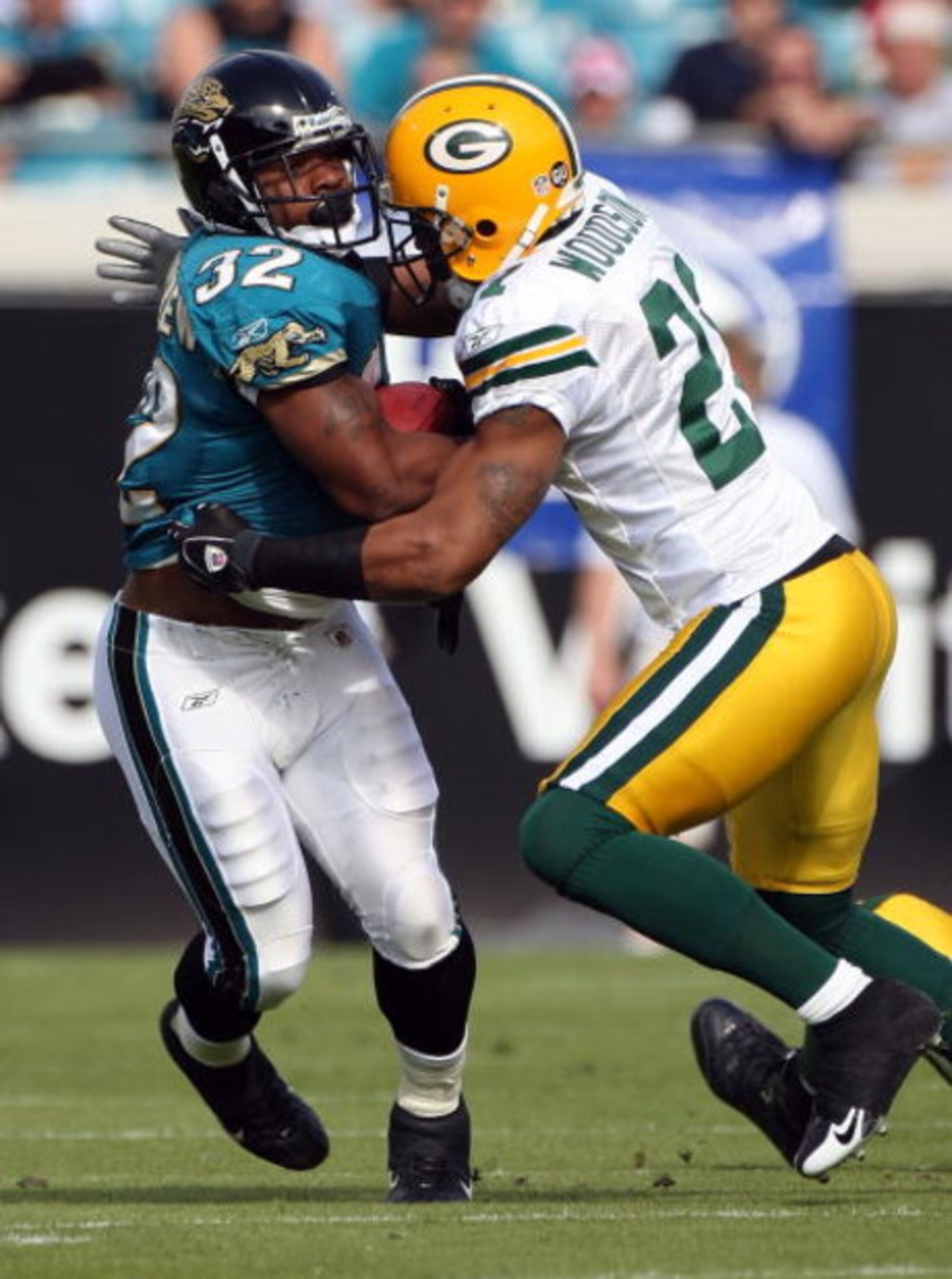 JACKSONVILLE, FL - DECEMBER 14:  Maurice Jones-Drew #32 of the Jacksonville Jaguars is tackled by Charles Woodson #21 of the Green Bay Packers during the game at Jacksonville Municipal stadium on December 14, 2008 in Jacksonville, Florida.  (Photo by Sam 