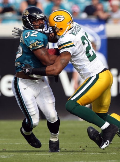 JACKSONVILLE, FL - DECEMBER 14:  Maurice Jones-Drew #32 of the Jacksonville Jaguars is tackled by Charles Woodson #21 of the Green Bay Packers during the game at Jacksonville Municipal stadium on December 14, 2008 in Jacksonville, Florida.  (Photo by Sam 