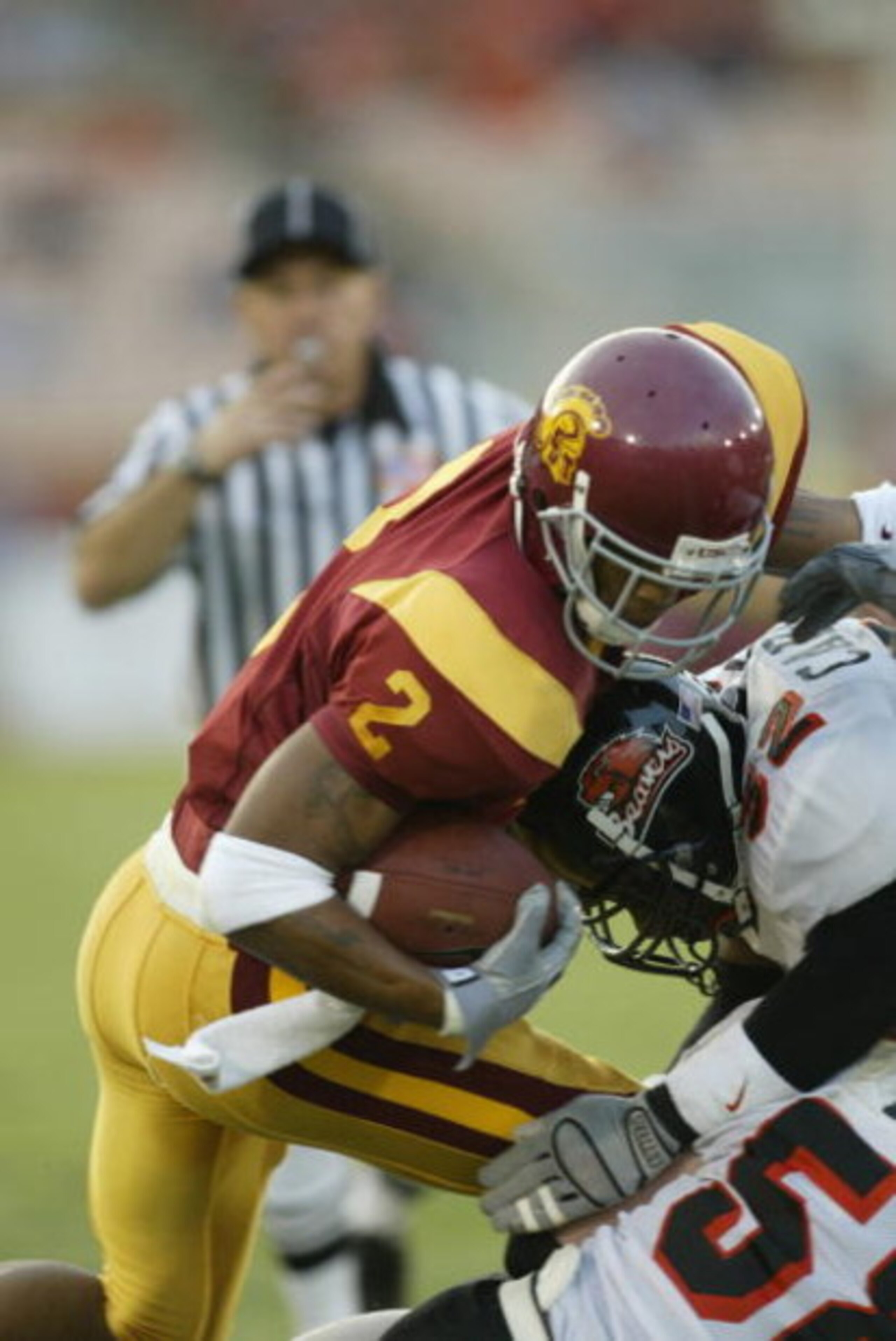 LOS ANGELES - SEPTEMBER 28:  Wide receiver Kareem Kelly #2 of the USC Trojans battles for extra yardage during the Pacific 10 Conference football game against the Oregon State Beavers on September 28, 2002 at the Los Angeles Coliseum in Los Angeles, Calif