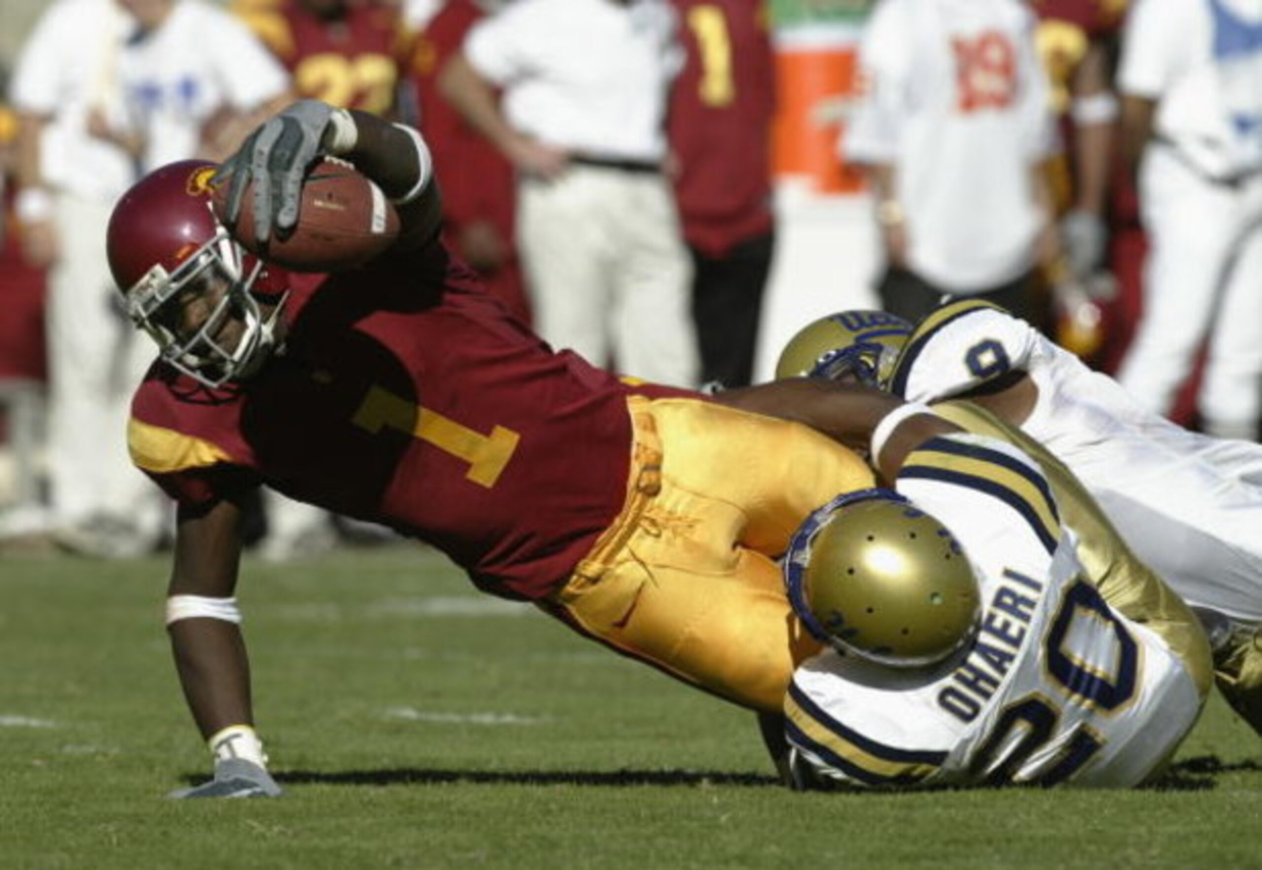 LOS ANGELES - NOVEMBER 22:  Mike Williams #1 of USC stretches after the catch as he is tackled by Glenn Ohaeri #20 of UCLA during the game at the Los Angeles Memorial Coliseum on November 22, 2003 in Los Angeles, California.  USC defeated UCLA 47-22.  (Ph