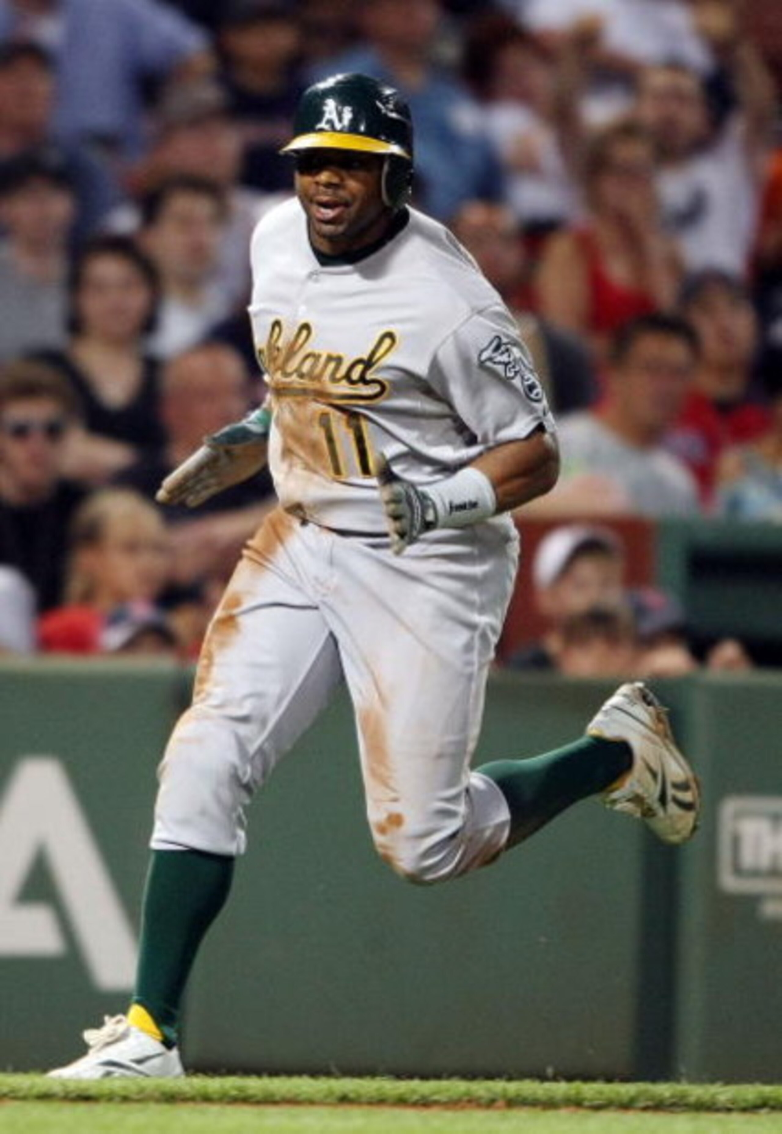BOSTON - JULY 28:  Rajai Davis #11 of the Oakland Athletics scores the game winning run in the 11th inning against the Boston Red Sox at Fenway Park July 28, 2009 in Boston, Massachusetts. The A's defeated the Red Sox 9-8 in 11 innings.  (Photo by Elsa/Ge
