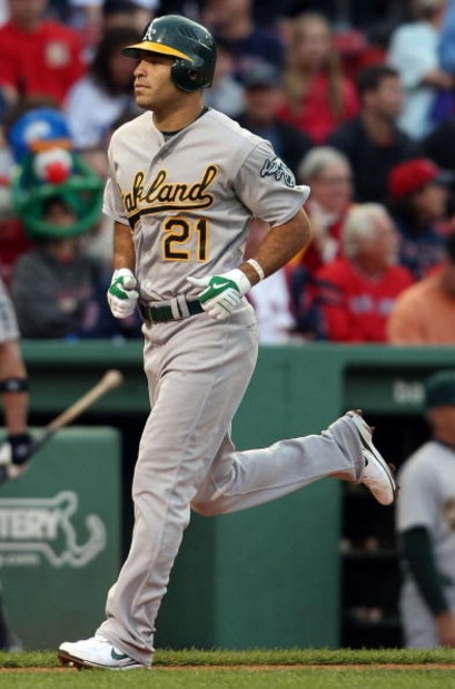 BOSTON - JULY 07:  Scott Hairston #21 of the Oakland Athletics heads for home plate after his solo home run in the first inning off a pitch by Josh Beckett of the Boston Red Sox non July 7, 2009 at Fenway Park in Boston, Massachusetts.  (Photo by Elsa/Get
