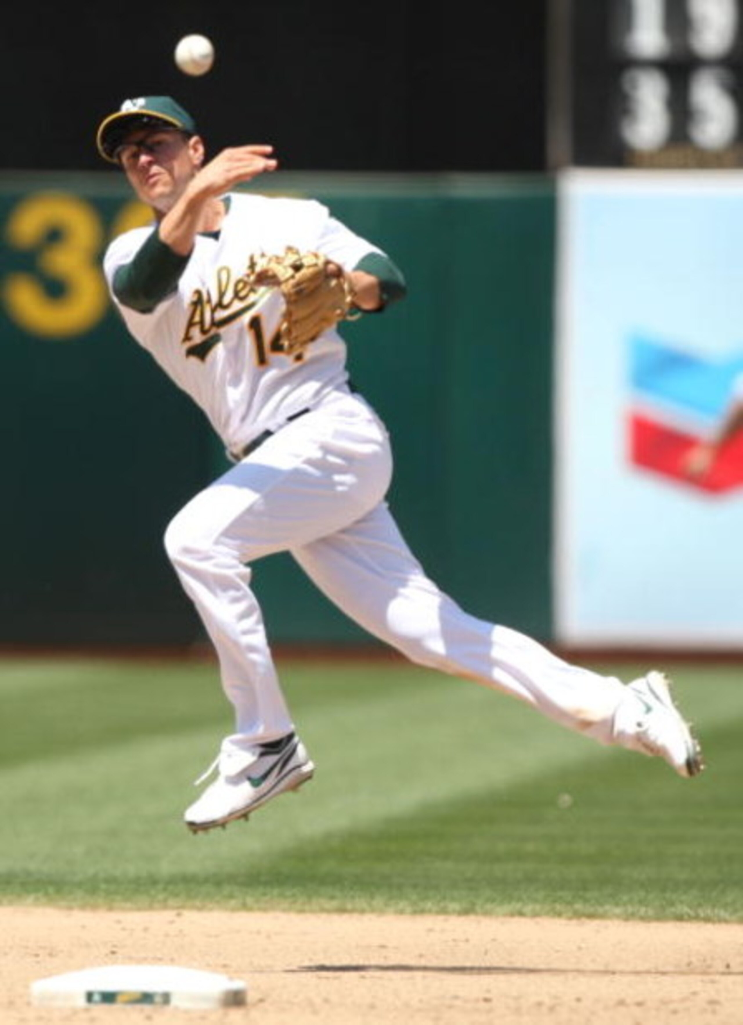OAKLAND, CA - JULY 01:  Mark Ellis #14 of the Oakland Athletics attempts to throw out Adam Everett in the eighth inning during action against the Detroit Tigers during a Major League Baseball game on July 1, 2009 at the Oakland Coliseum in Oakland, Califo