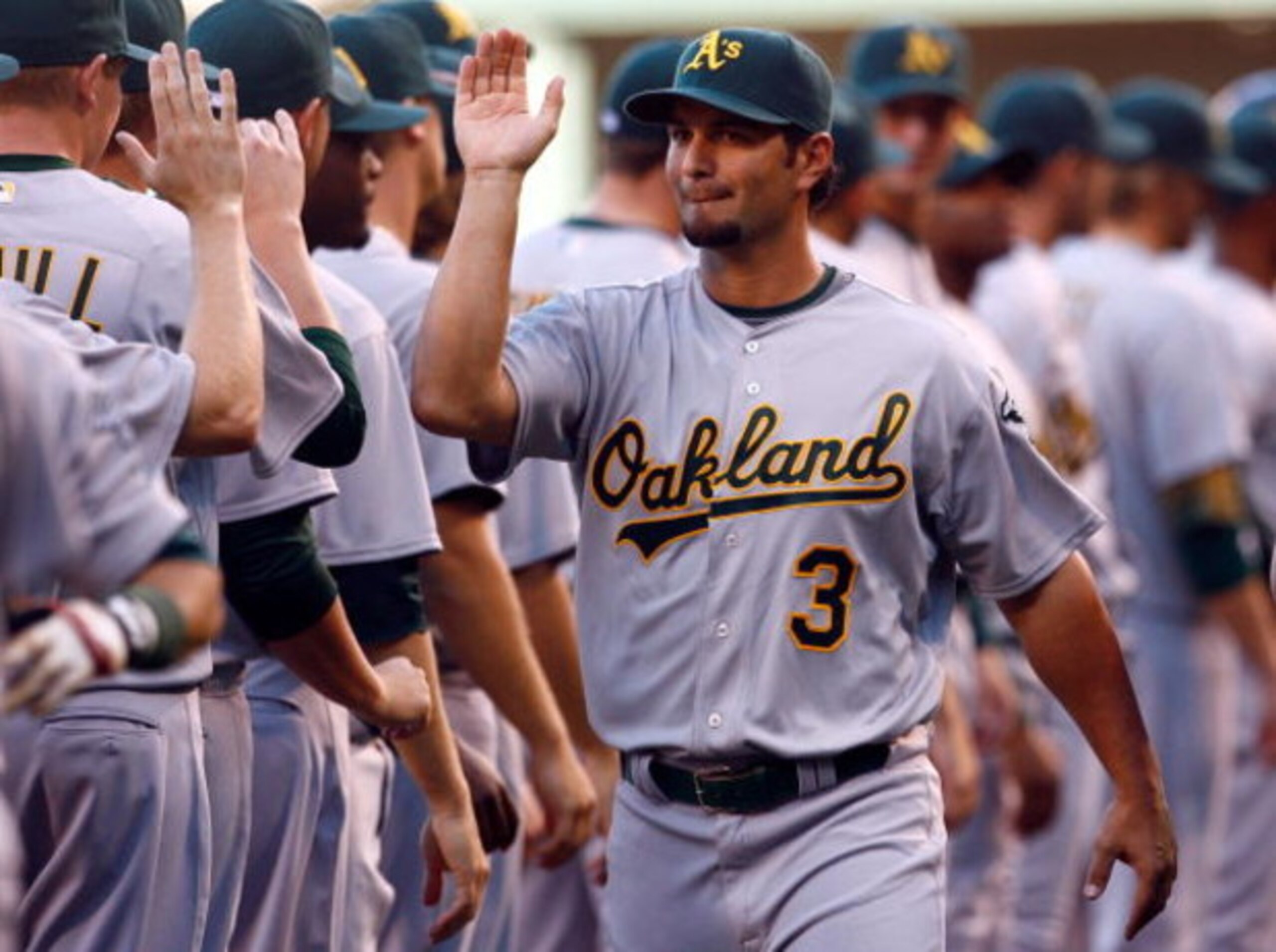 ANAHEIM, CA - APRIL 06:  Eric Chavez #3 of the Oakland Athletics receives high fives from his teammates prior to the start of the opening day game against the Los Angeles Angels of Anaheim at Angel Stadium on April 6, 2009 in Anaheim, California.  The Ang