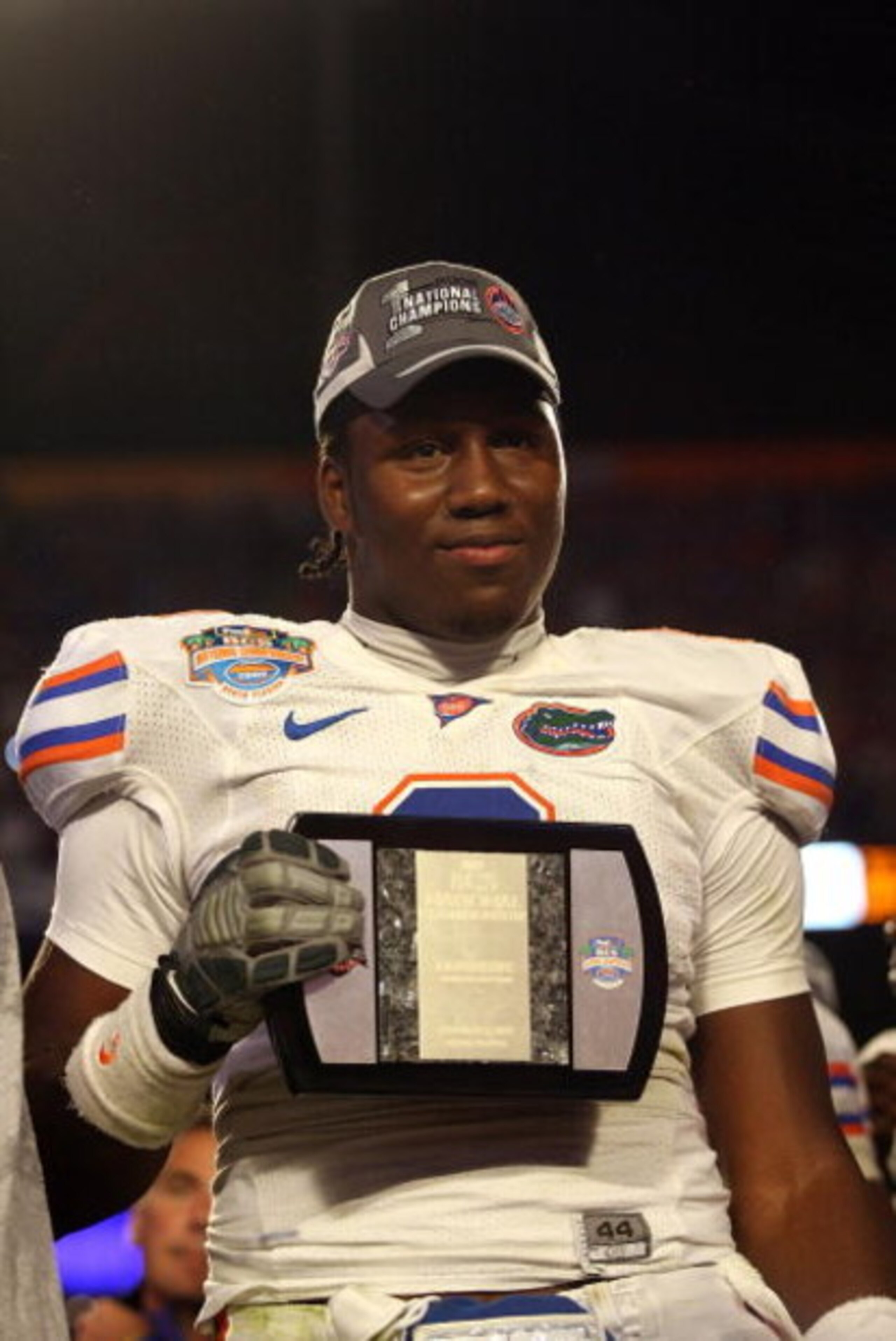 MIAMI - JANUARY 08:  Carlos Dunlap #8 of the Florida Gators celebrate with his defensive player of the game award after their 24-14 win against the Oklahoma Sooners during the FedEx BCS National Championship game at Dolphin Stadium on January 8, 2009 in M