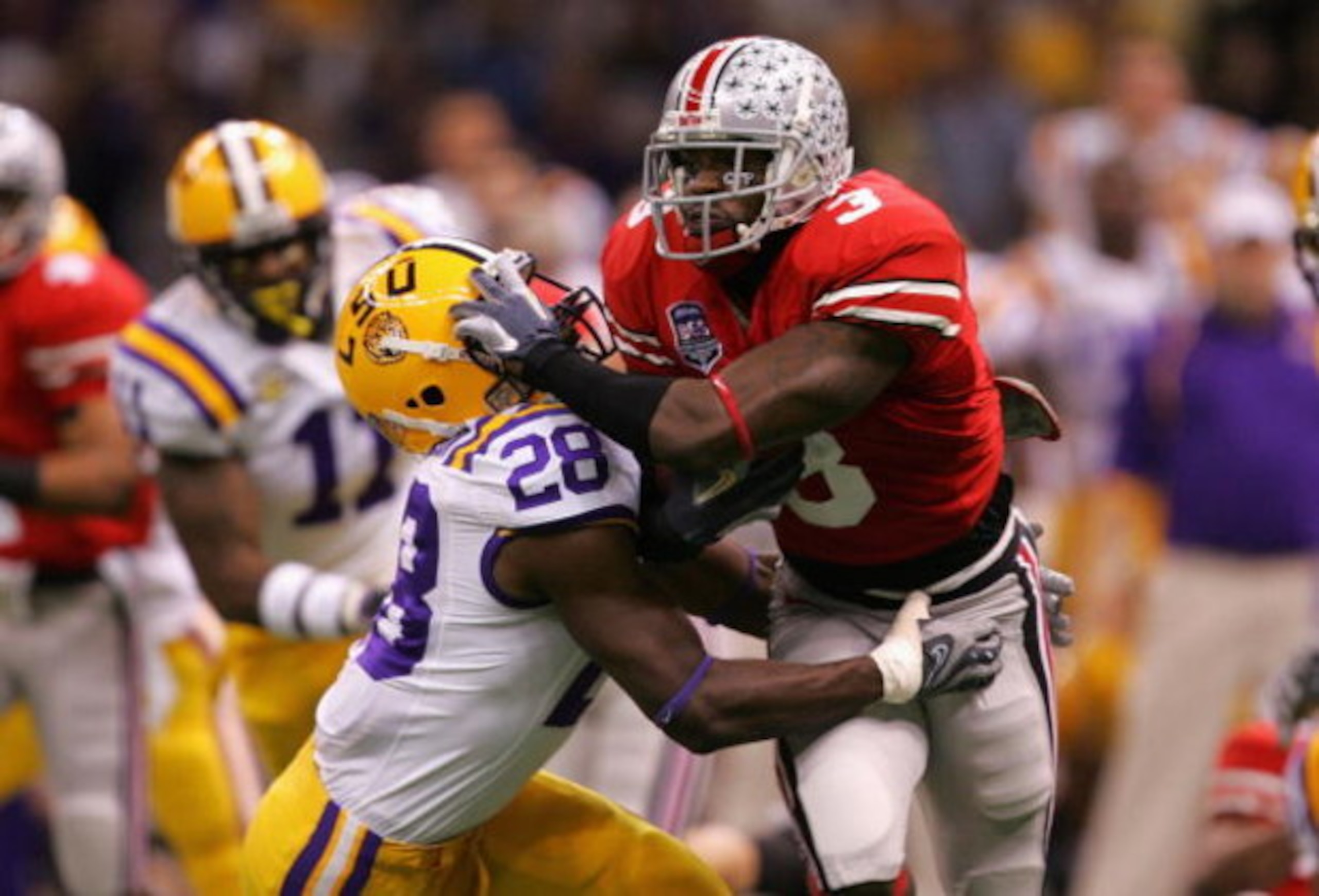NEW ORLEANS - JANUARY 07:  Brandon Saine #3 of the Ohio State Buckeyes tries to break a tackle from R.J. Jackson #28 of the Louisiana State University Tigers during the AllState BCS National Championship on January 7, 2008 at the Louisiana Superdome in Ne