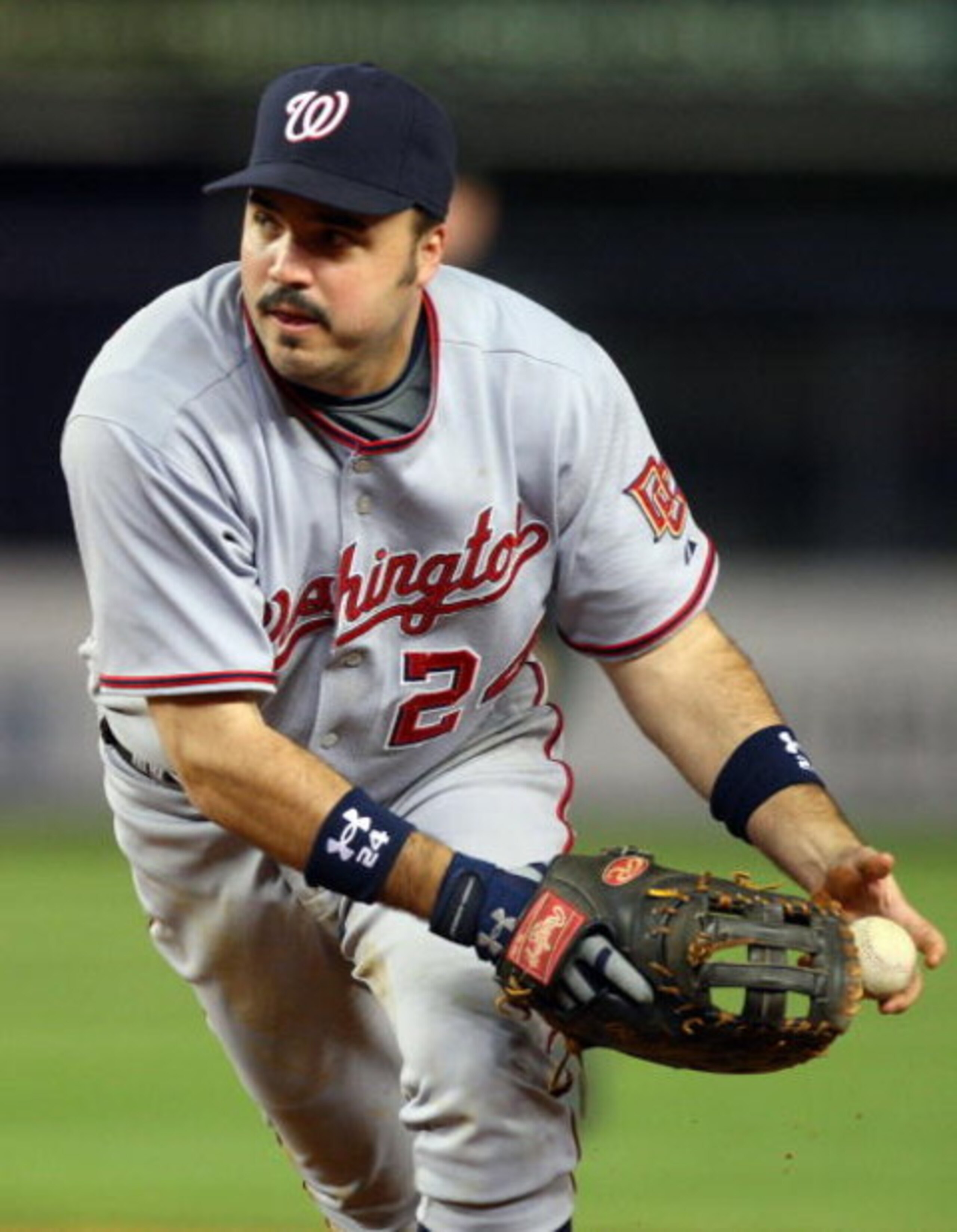 NEW YORK - JUNE 17:  Nick Johnson #24 of the Washington Nationals flips the ball to first base for an out against the New York Yankees on June 17, 2009 at Yankee Stadium in the Bronx borough of New York City. The Nationals defeated the Yankees 3-2.  (Phot