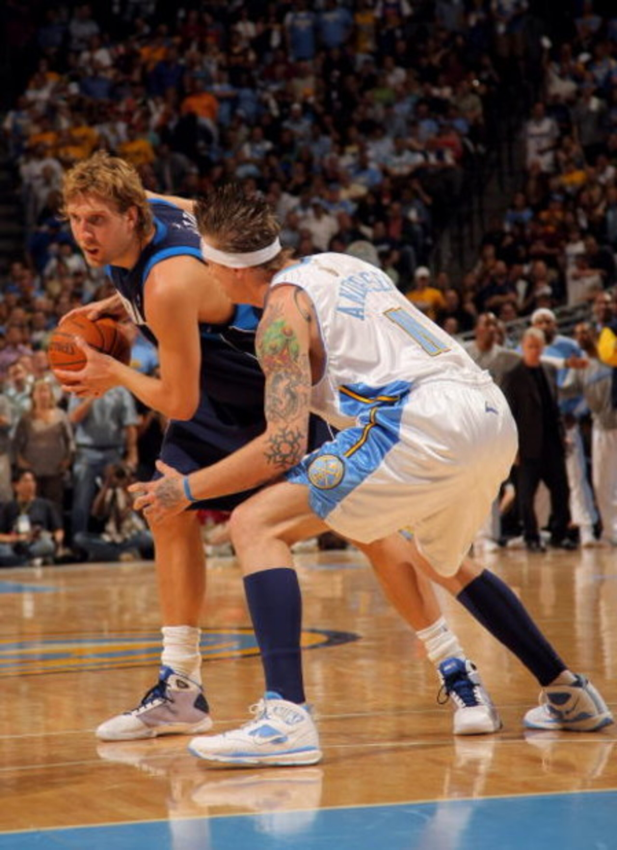 DENVER - MAY 13:  Dirk Nowitzki #41 of the Dallas Mavericks tries to drive against Chris Andersen #11 of the Denver Nuggets in Game Five of the Western Conference Semifinals during the 2009 NBA Playoffs at Pepsi Center on May 13, 2009 in Denver, Colorado.