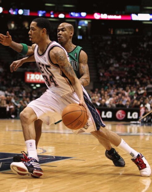 EAST RUTHERFORD, NJ - MARCH 04:  Devin Harris #34 of the New Jersey Nets dribbles the ball against Stephon Marbury #8 of Boston Celtics during their game on March 4th, 2009 at The Izod Center in East Rutherford, New Jersey.  NOTE TO USER: User expressly a