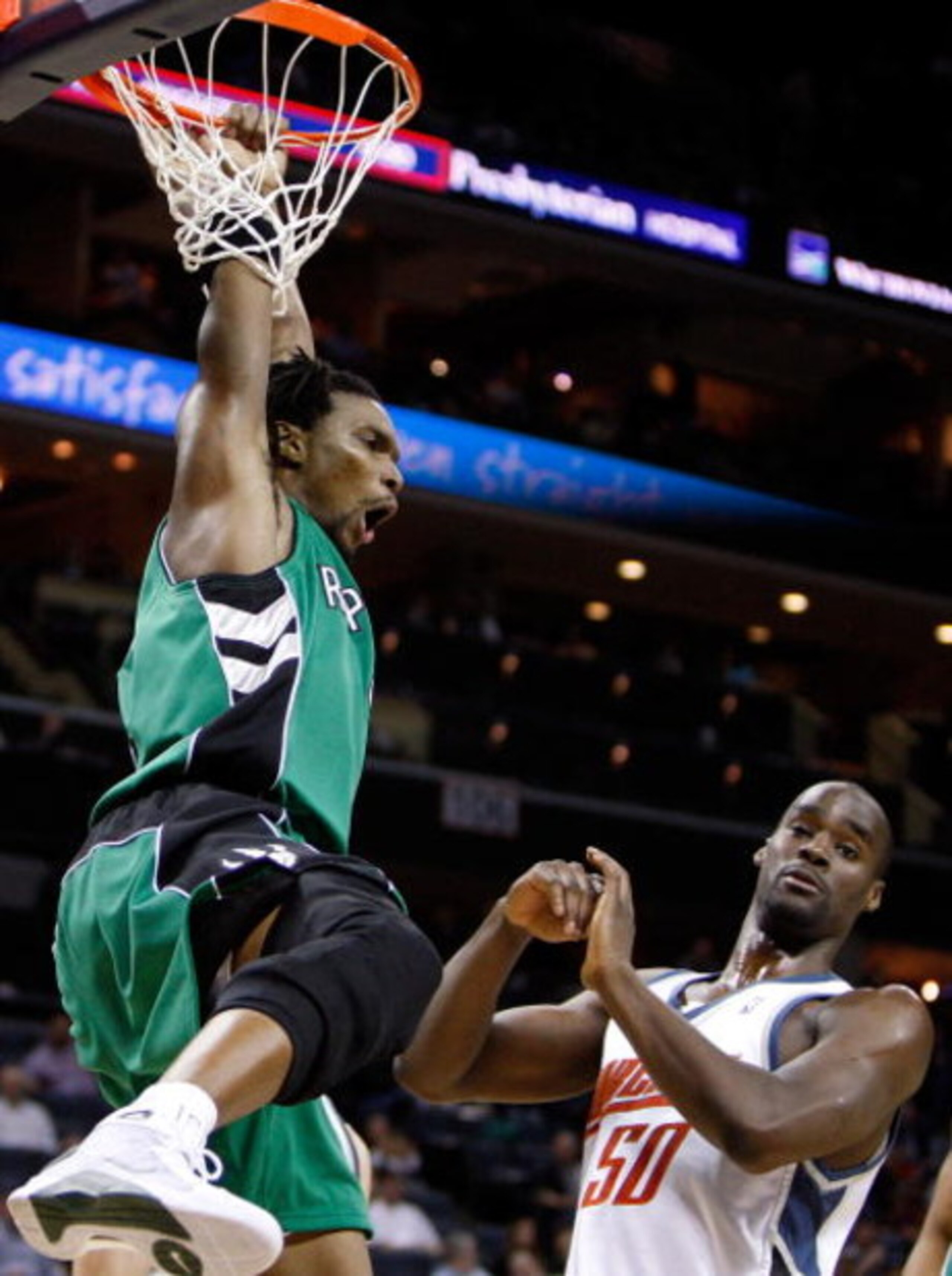 CHARLOTTE, NC - MARCH 16:  Chris Bosh #4 of the Toronto Raptors reacts after a dunk against Emeka Okafor #50 of the Charlotte Bobcats during their game at Time Warner Cable Arena on March 16, 2009 in Charlotte, North Carolina.  NOTE TO USER: User expressl