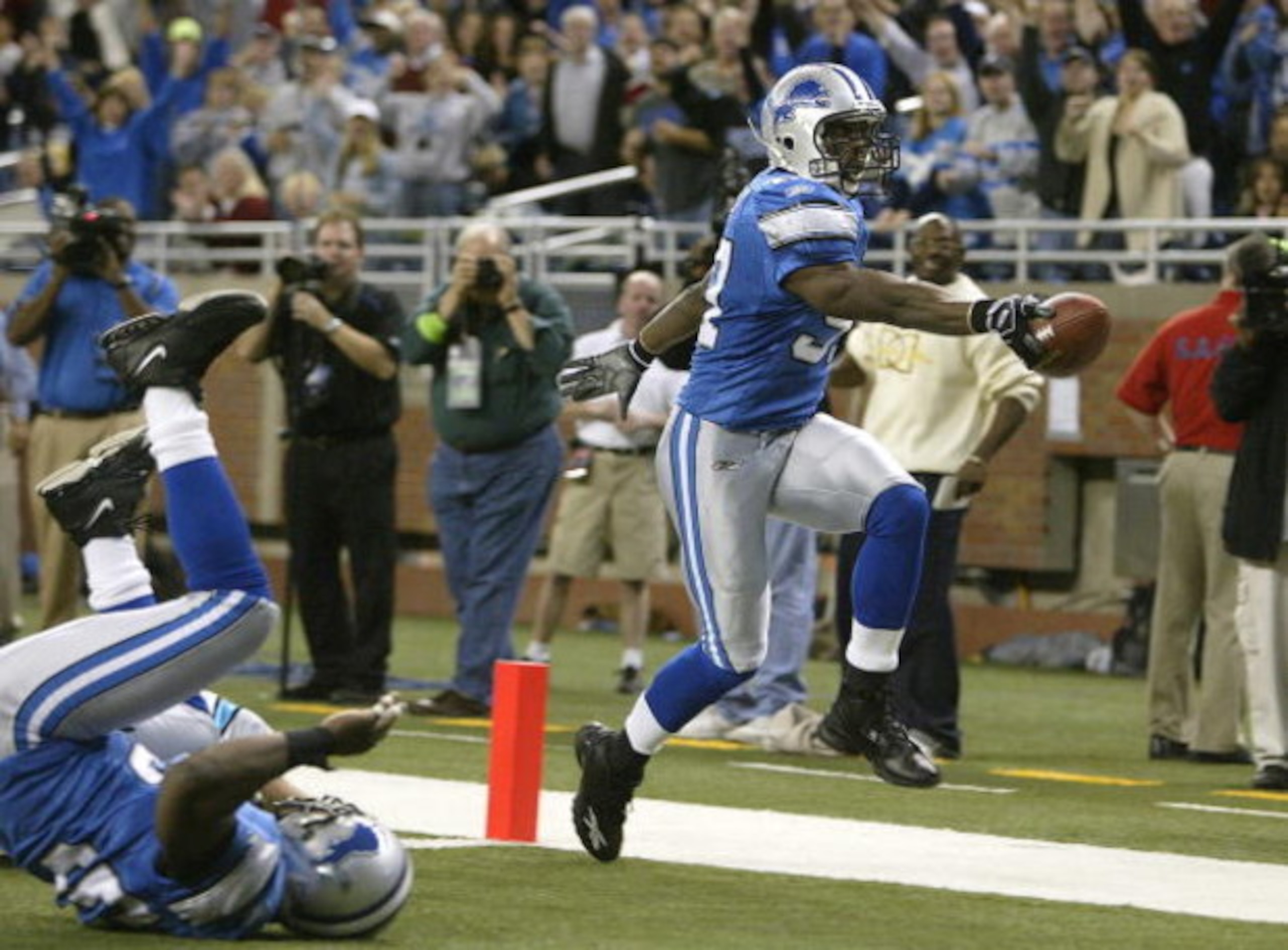 DETROIT - OCTOBER 16:  Boss Bailey #97 of the Detroit Lions scores a touchdown after intercepting a pass against the Carolina Panthers on October 16, 2005 at Ford Field in Detroit, Michigan.  (Photo by Tom Pidgeon/Getty Images)