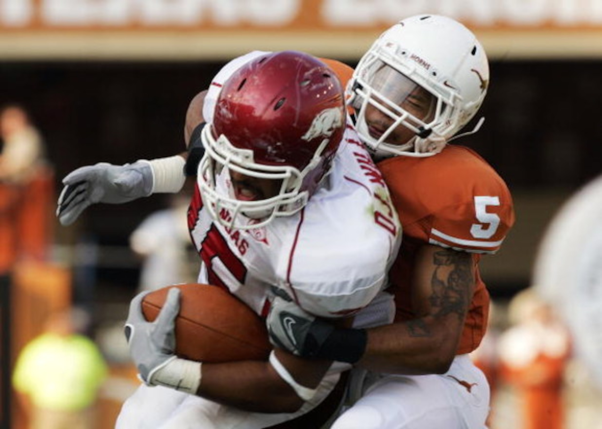 AUSTIN, TX - SEPTEMBER 27:  Safety Ben Wells #5 of the Texas Longhorns wrestles tight end D.J. Williams #45 of the Arkansas Razorbacks in the fourth quarter on September 27, 2008 at Darrell K Royal-Texas Memorial Stadium in Austin, Texas.  Texas won 52-10