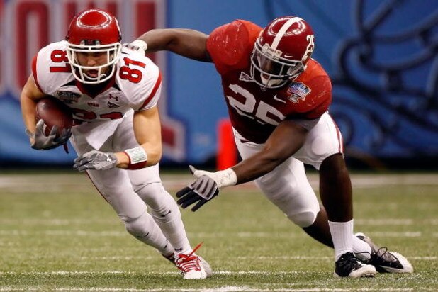 NEW ORLEANS - JANUARY 02:  Wide receiver Bradon Godfrey #81 of the Utah Utes runs after making a catch as he attempts to avoid a tackle by Rolando McClain #25 of the Alabama Crimson Tide in the first half during the 75th Allstate Sugar Bowl at the Louisia