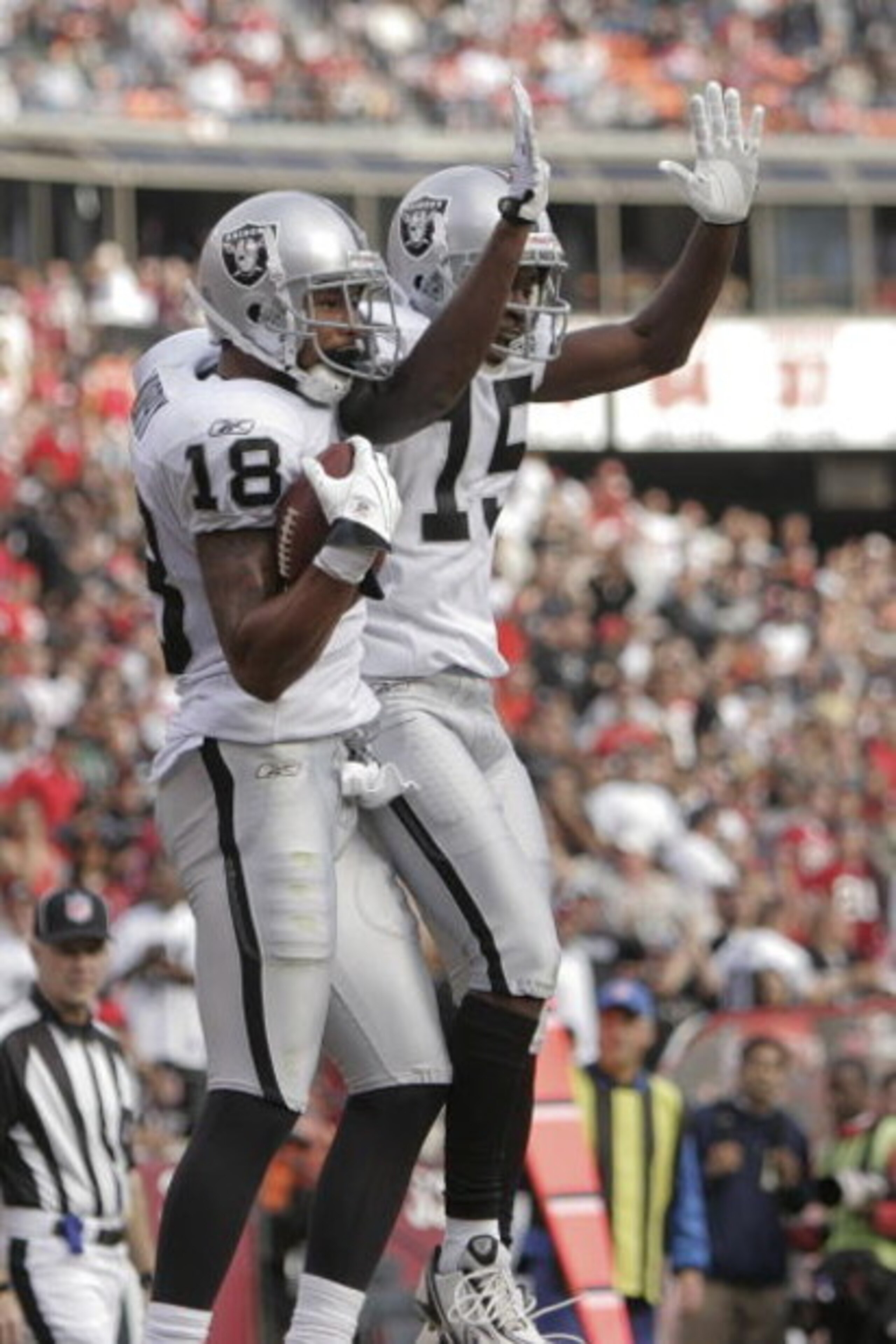 SAN FRANCISCO - AUGUST 22: Oakland Raiders wide receiver Louis Murphy #18 raises celebrates with Oakland Raiders wide receiver Johnnie Lee Higgins #15 after making a touchdown in the 2nd quarter as the San Francisco 49ers host the Oakland Raiders at Cand SAN FRANCISCO - AUGUST 22: Oakland Raiders wide receiver Louis Murphy #18 raises celebrates with Oakland Raiders wide receiver Johnnie Lee Higgins #15 after making a touchdown in the 2nd quarter as the San Francisco 49ers host the Oakland Raiders at Cand