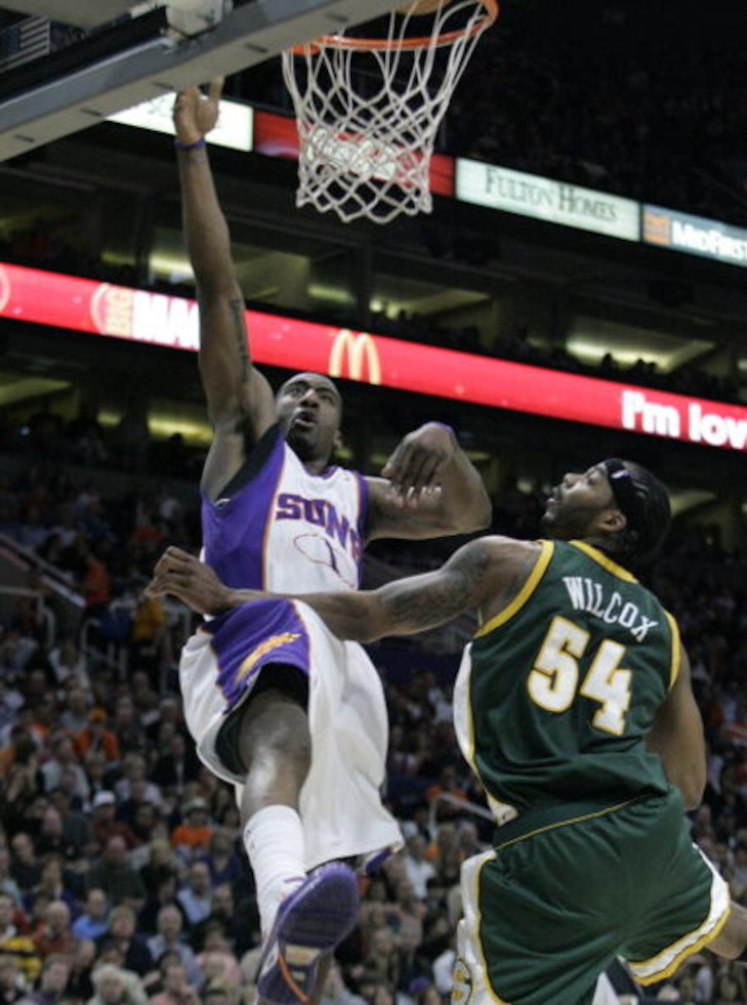 PHOENIX - FEBRUARY 8:  Amare' Stoudemire #1 of the Phoenix Suns lays the ball in against Chris Wilcox #54 of the Seattle SuperSonics on February 8, 2008 at US Airways Center in Phoenix, Arizona. NOTE TO USER: User expressly acknowledges and agrees that, b