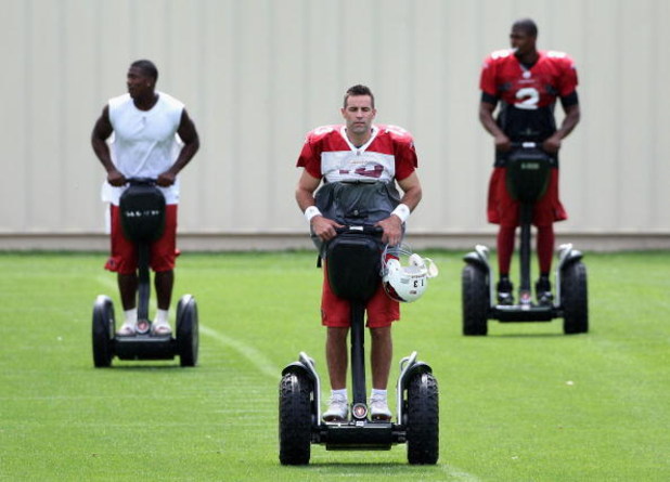 FLAGSTAFF, AZ - JULY 31: Quarterback Kurt Warner #13 of the Arizona Cardinals rides a segway across the field with teammates before the evening team training camp at Northern Arizona University on July 31, 2009 in Flagstaff, Arizona. (Photo by Christian P
