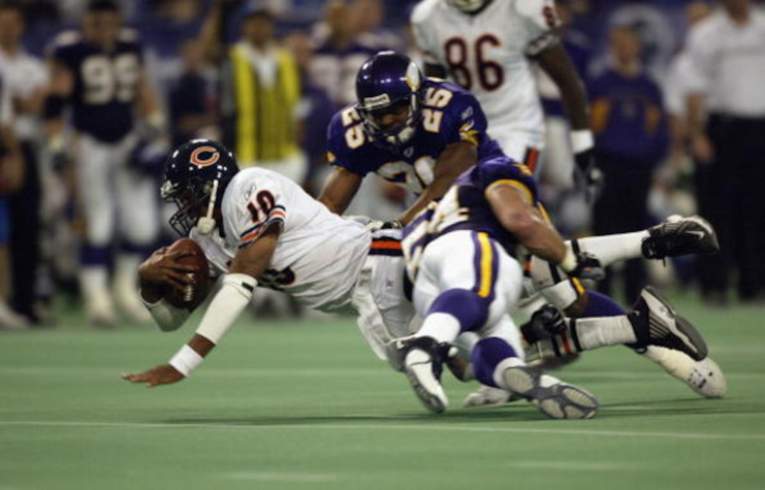 MINNEAPOLIS - OCTOBER 27: Quarterback Henry Burris #10 of the Chicago Bears is tackled by Greg Biekert #54 and Eric Kelly #25 of the Minnesota Vikings in the fourth quarter at the Hubert H. Humphrey Metrodome on October 27, 2002 in Minneapolis, Minnesota MINNEAPOLIS - OCTOBER 27: Quarterback Henry Burris #10 of the Chicago Bears is tackled by Greg Biekert #54 and Eric Kelly #25 of the Minnesota Vikings in the fourth quarter at the Hubert H. Humphrey Metrodome on October 27, 2002 in Minneapolis, Minnesota