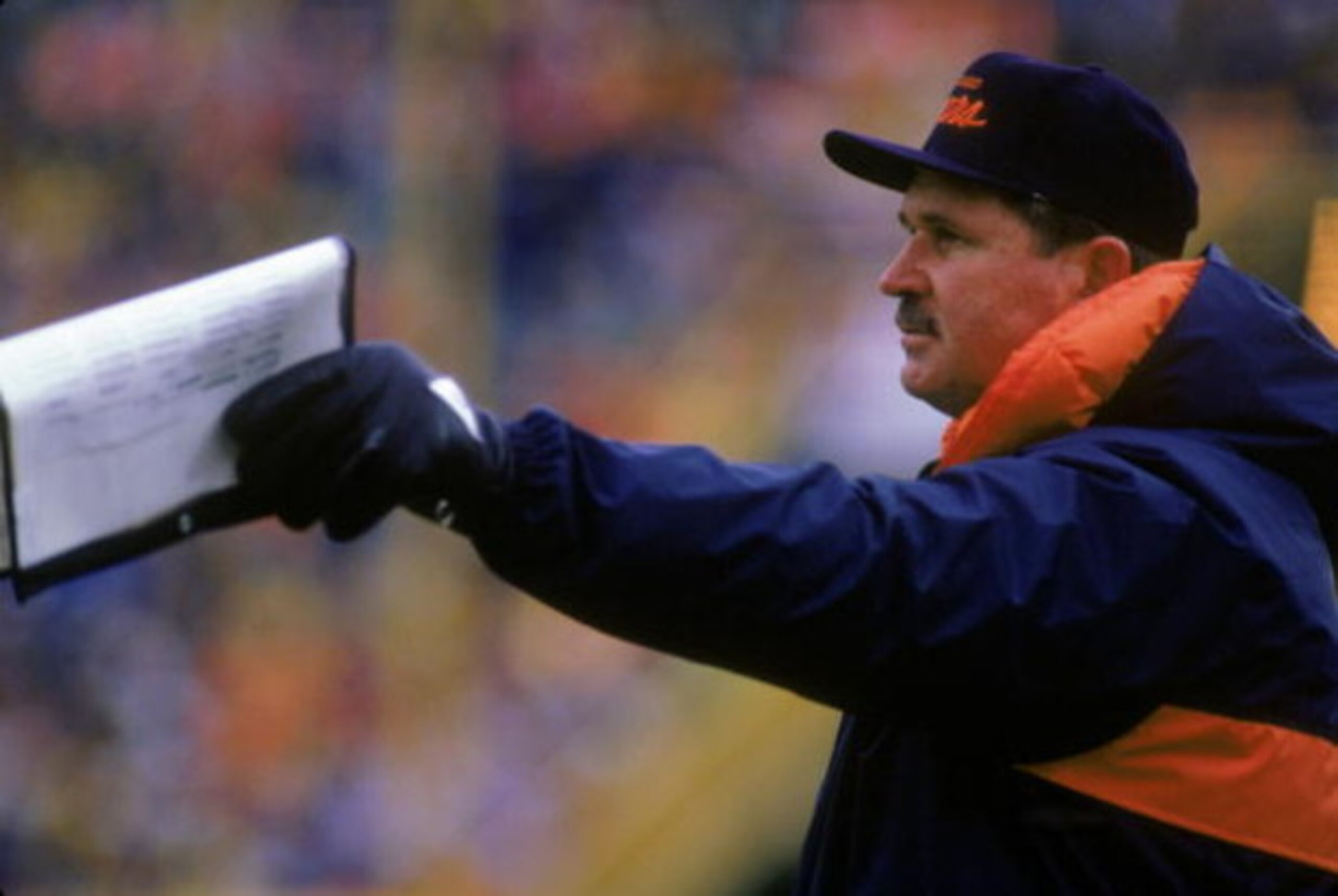 1987:  Head coach Mike Ditka of the Chicago Bears points to the field with his play list from the sidelines during a 1987 season game.  (Photo by Jonathan Daniel/Getty Images)
