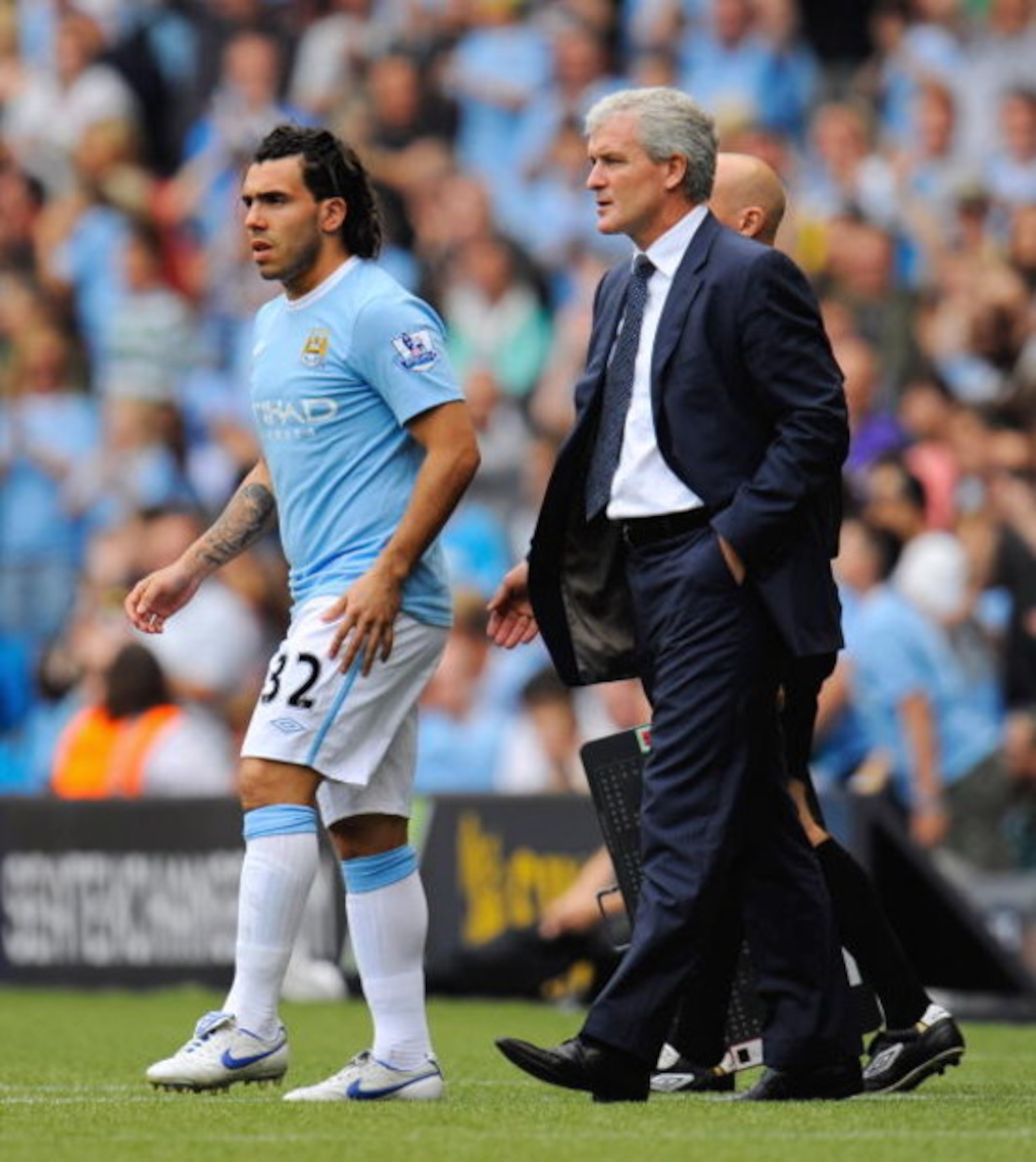 MANCHESTER, ENGLAND - AUGUST 08:  Carlos Tevez of Manchester City comes on as a sub as manager Mark Hughes looks on during the pre season friendly match between Manchester City and Celtic at the City of Manchester Stadium on August 8, 2009 in Manchester, 