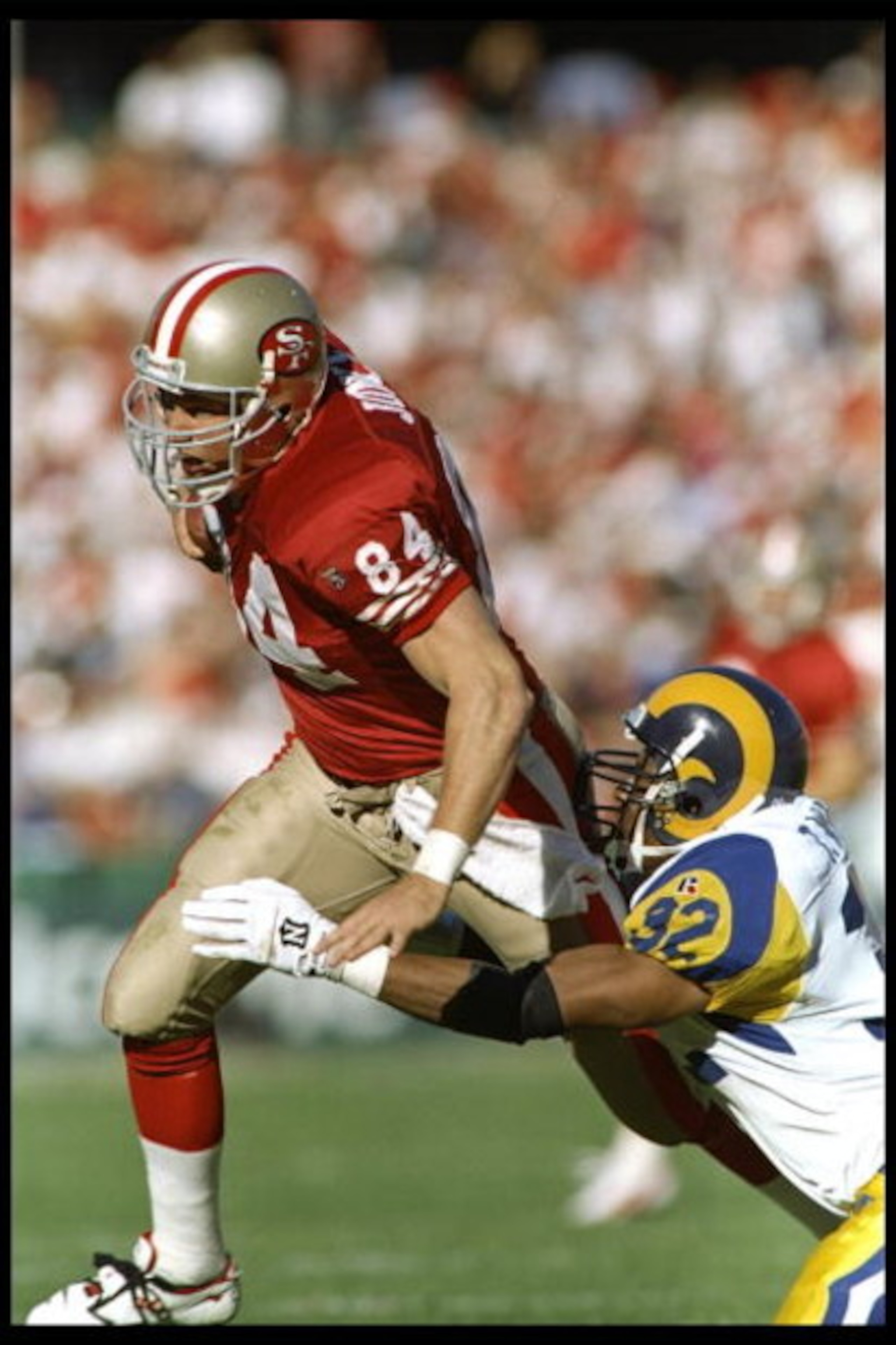 26 Nov 1995:  Defensive back Toby Wright of the St. Louis Rams tries to tackle tight end Brent Jones of the San Francisco 49ers during a game at 3Com Park in San Francisco, California.  The 49ers won the game 41-13.    Mandatory Credit: Otto Greule Jr.  /