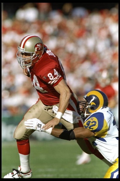 26 Nov 1995:  Defensive back Toby Wright of the St. Louis Rams tries to tackle tight end Brent Jones of the San Francisco 49ers during a game at 3Com Park in San Francisco, California.  The 49ers won the game 41-13.    Mandatory Credit: Otto Greule Jr.  /