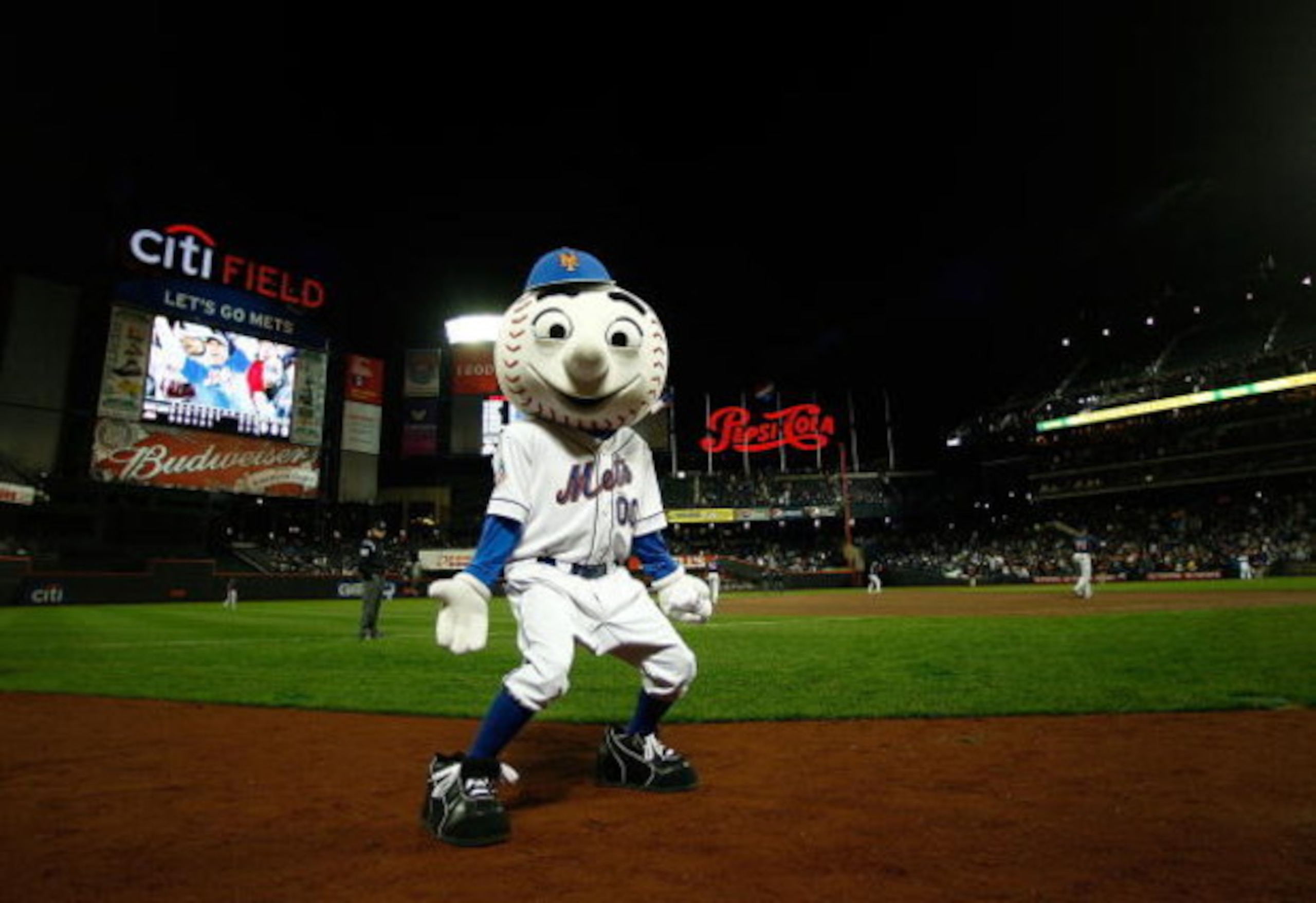 NEW YORK - APRIL 03:  Mr Met  gets the crowd going during an exhibition game between the New York Mets and the Boston Red Sox on April 3, 2009 at Citi Field in the Flushing neighborhood of the Queens borough of New York City. The game marks the first time