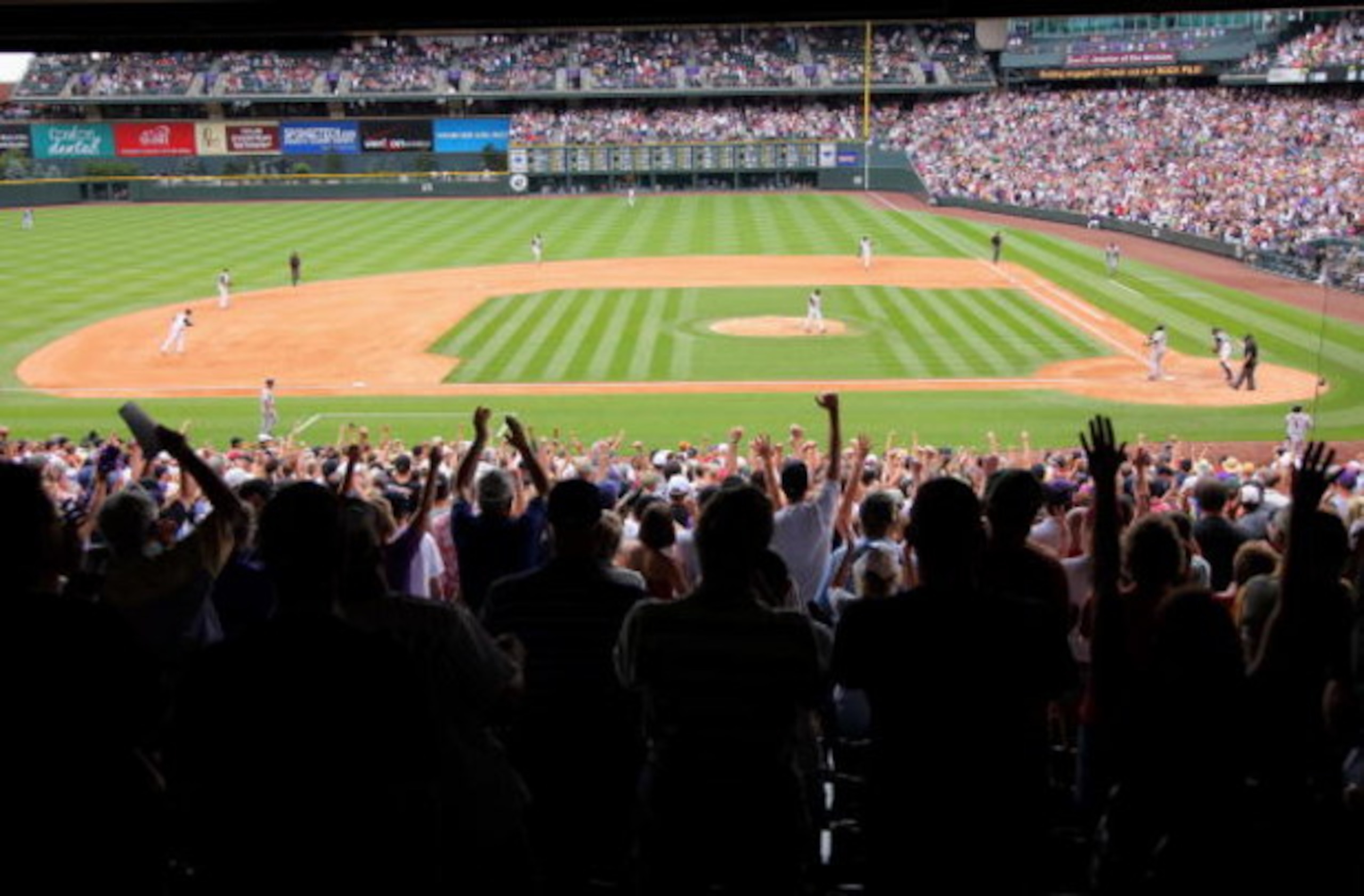 DENVER - JULY 26:  Rockies fans celebrate as relief pitcher Huston Street #16 of the Colorado Rockies strikes out Juan Uribe #5 of the San Francisco Giants for the final out at Coors Field on July 26, 2009 in Denver, Colorado. Street recorded his 25th sav