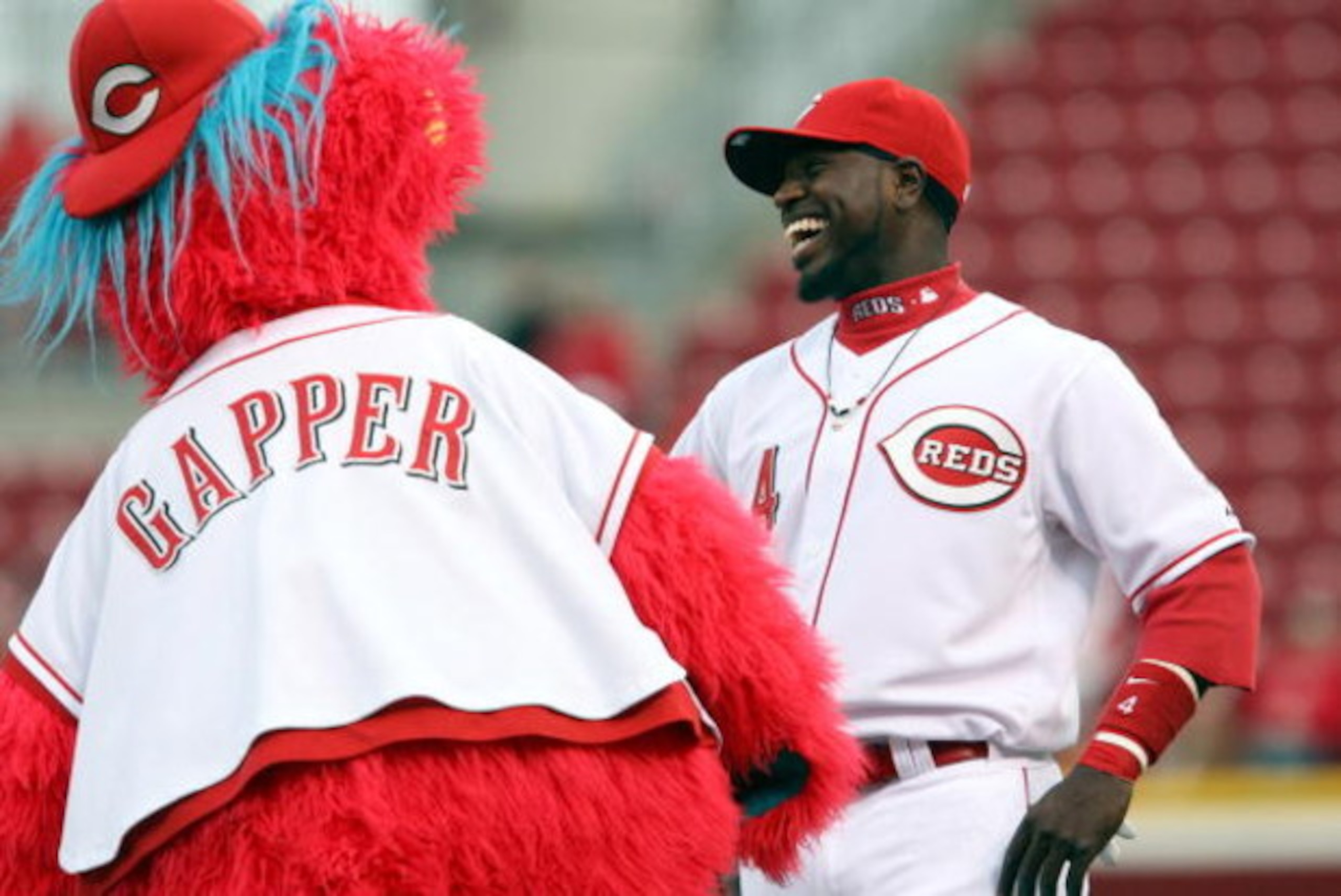 CINCINNATI, OH - APRIL 8:  Brandon Phillips #4 of the Cincinnati Reds laughs with mascot Gapper prior to the game against the New York Mets on April 8, 2009 at Great American Ballpark in Cincinnati, Ohio.  The Mets won 9-7.  (Photo by Mark Lyons/Getty Ima