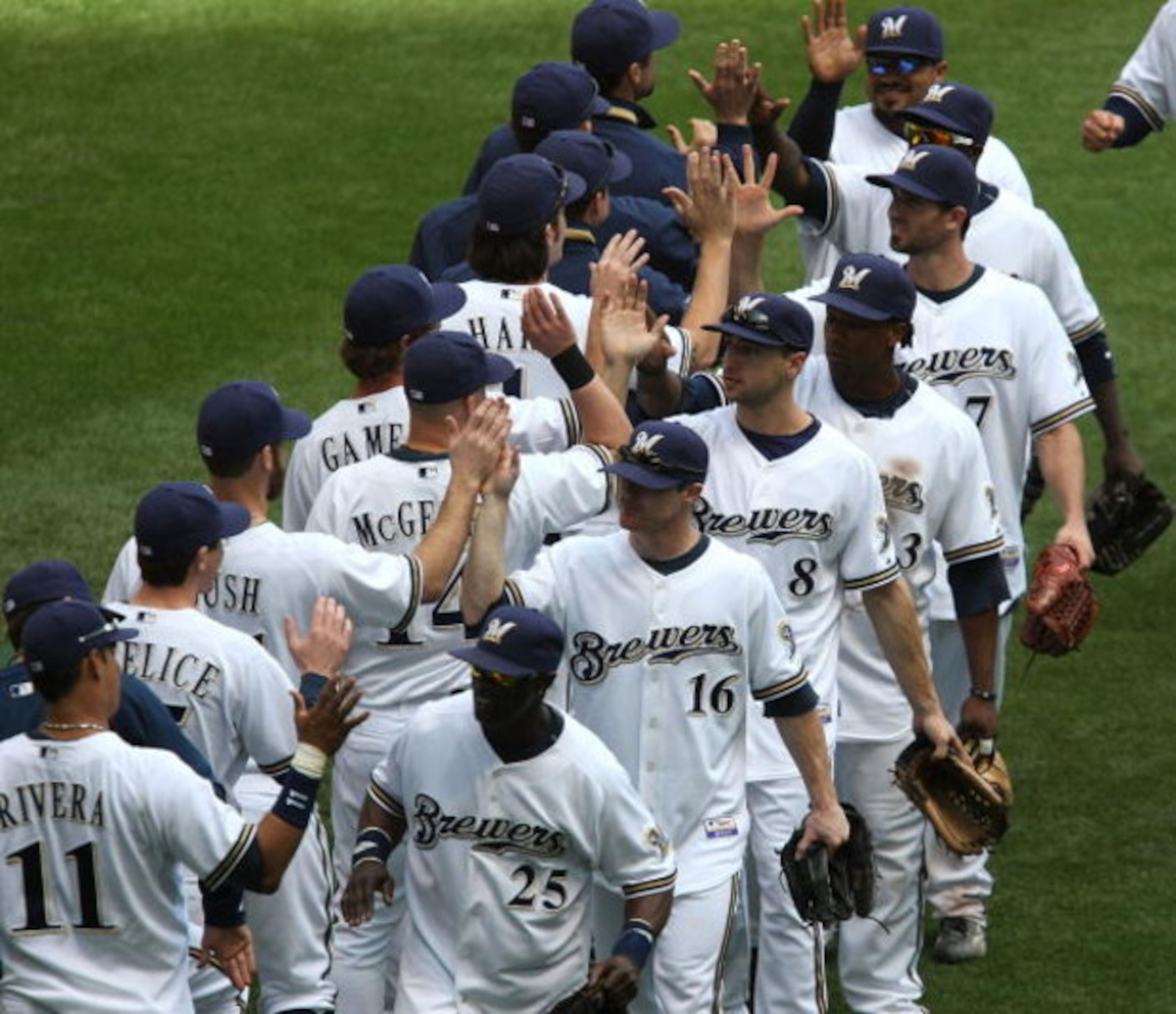 MILWAUKEE - MAY 14: Members of the Milwaukee Brewers including Mike Cameron #25, Chris Duffy #16, Ryan Braun #8 and Rickie Weeks #23 celebrate a win over the Florida Marlins on May 14, 2009 at Miller Park in Milwaukee, Wisconsin. The Brewers defeated the 