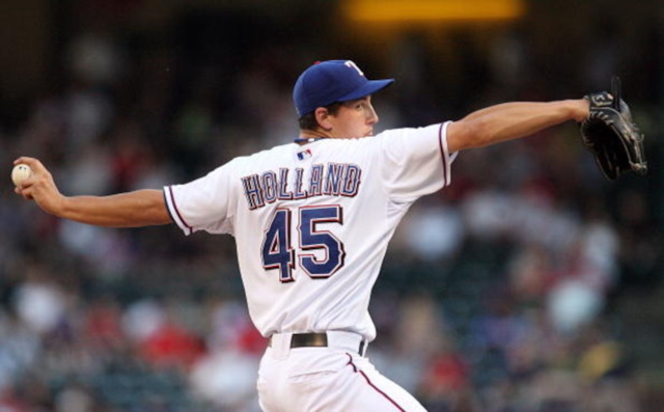 ARLINGTON, TX - MAY 27:  Pitcher Derek Holland #45 of the Texas Rangers throws against the New York Yankees in the first inning on May 27, 2009 at Rangers Ballpark in Arlington, Texas.  (Photo by Ronald Martinez/Getty Images)