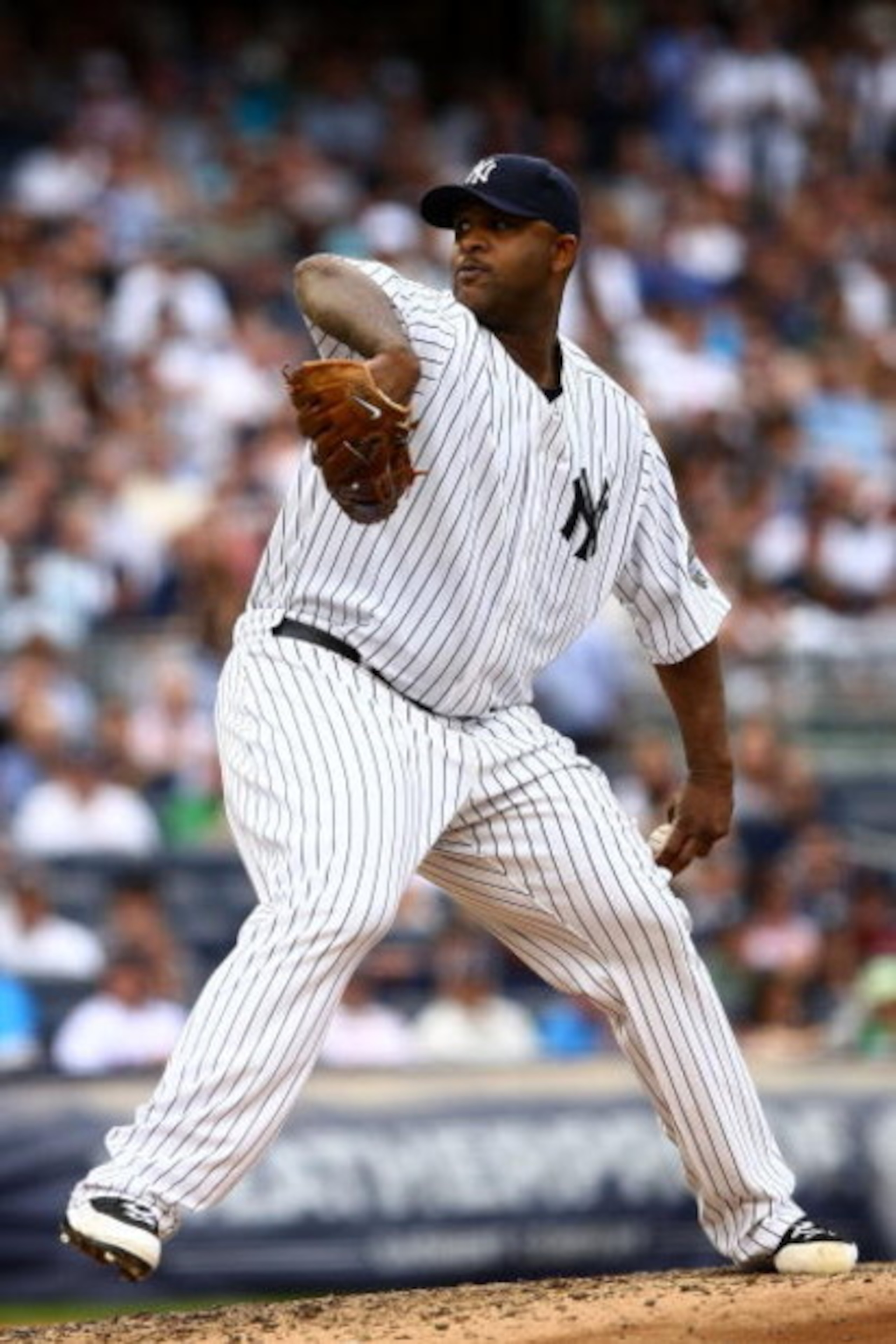 NEW YORK - AUGUST 08:  CC Sabathia #52 of the New York Yankees pitches against the Boston Red Sox during their game on August 8, 2009 at Yankee Stadium in the Bronx borough of New York City.  (Photo by Chris McGrath/Getty Images)