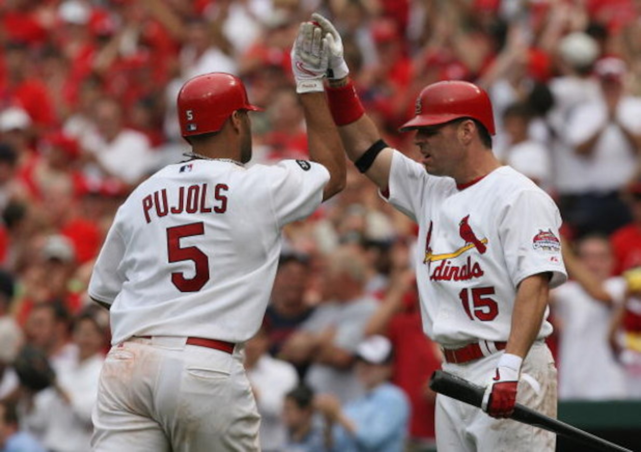ST. LOUIS, MO - JUNE 8: Jim Edmonds #15 of the St. Louis Cardinals congratulates teammate Albert Pujols #5 after Pujols knocked in three runs against the Milwaukee Brewers at Busch Stadium July 29, 2007 in St. Louis, Missouri.  The Cardinals beat the Brew