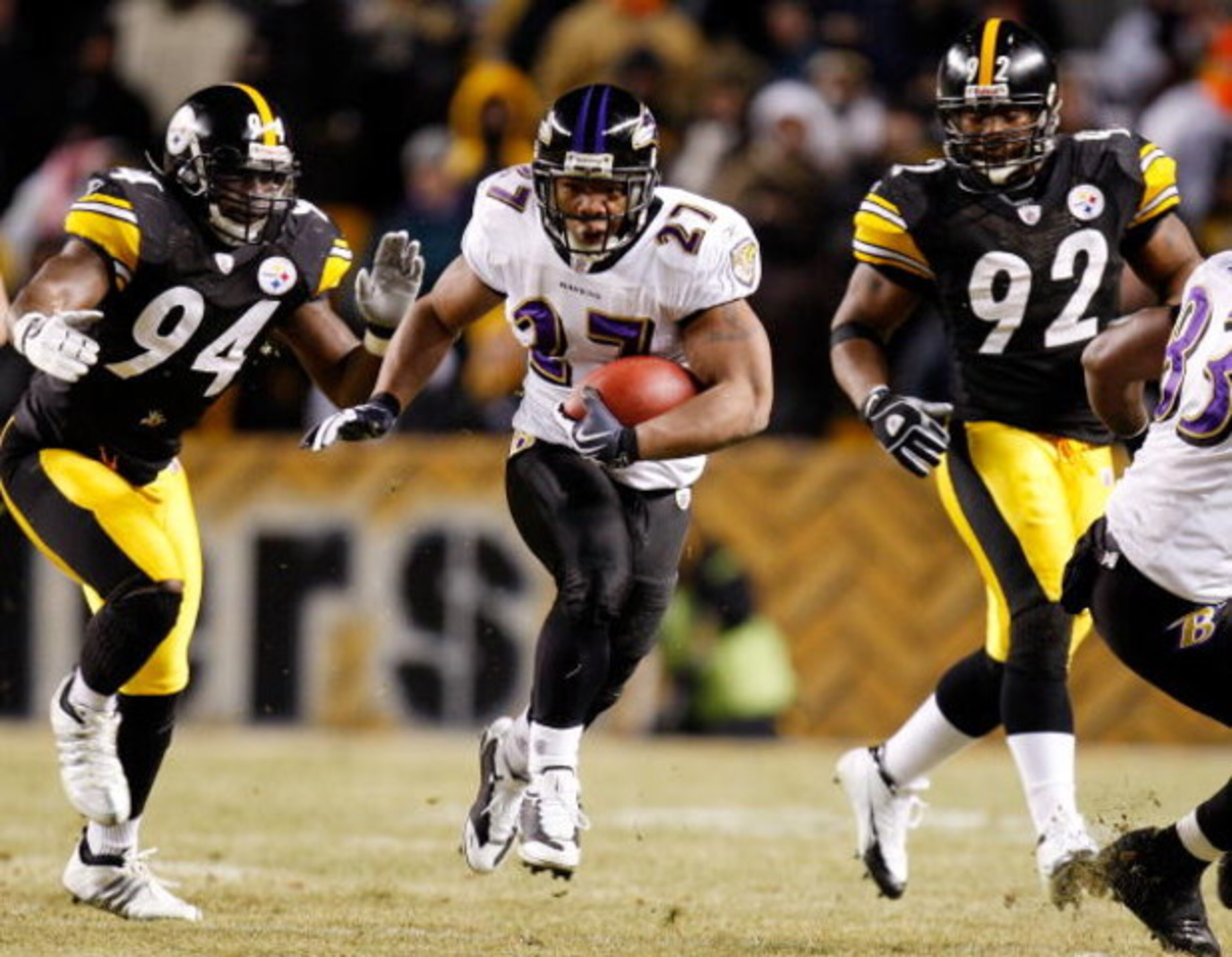 PITTSBURGH - JANUARY 18:  Running back Ray Rice #27 of the Baltimore Ravens runs the ball against linebacker linebackers Lawrence Timmons #94 and James Harrison #92 of the Pittsburgh Steelers during the second quarter of the AFC championship game on Janua