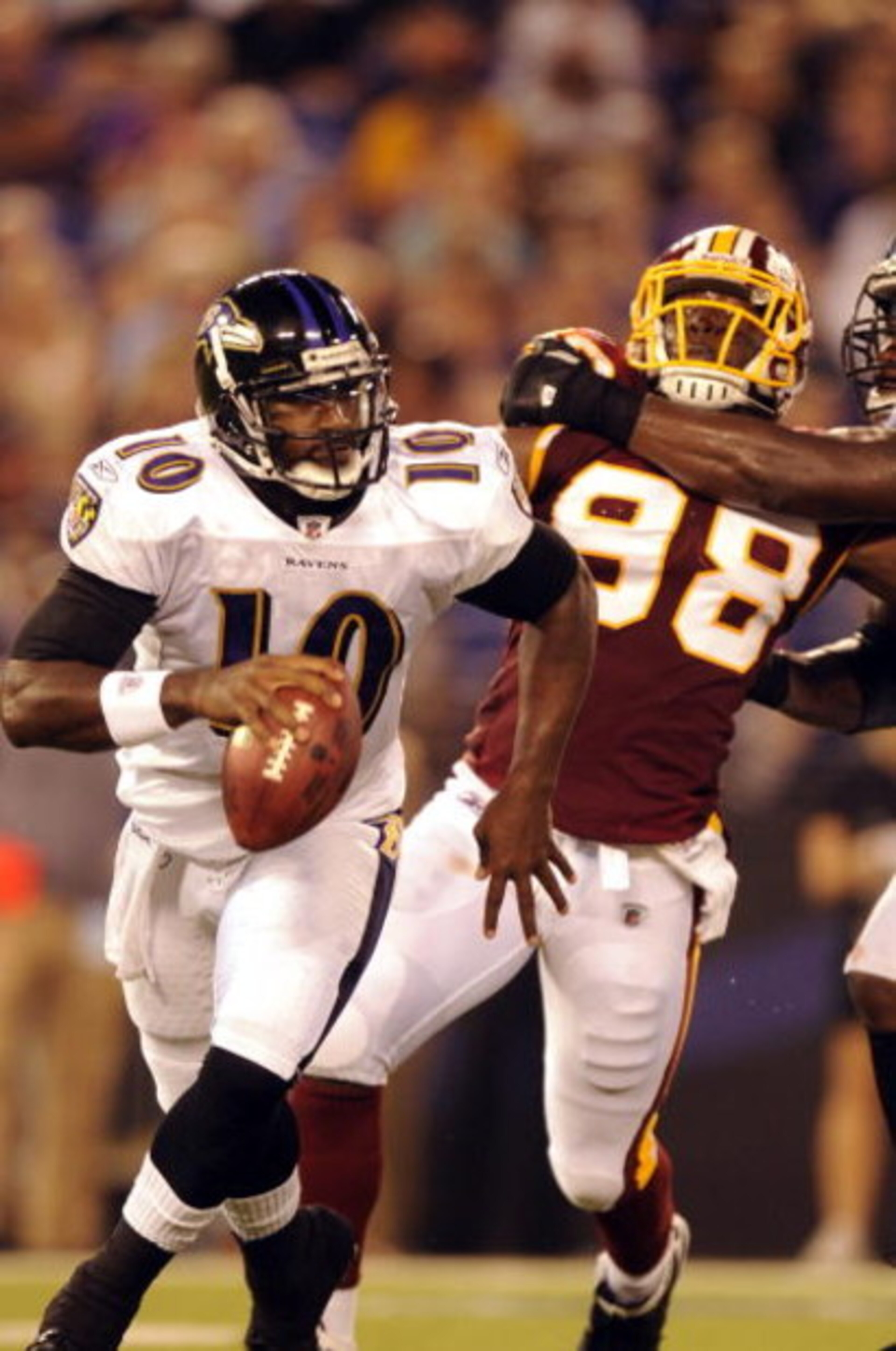 BALTIMORE, MD - AUGUST 13:  Quarterback Troy Smith #10 of the Baltimore Ravens is chased by Brian Orakpo #98 of the Washington Redskins during a NFL preseason football game against the Washington Redskins on August 13, 2009 at M & T Bank Stadium in Baltim