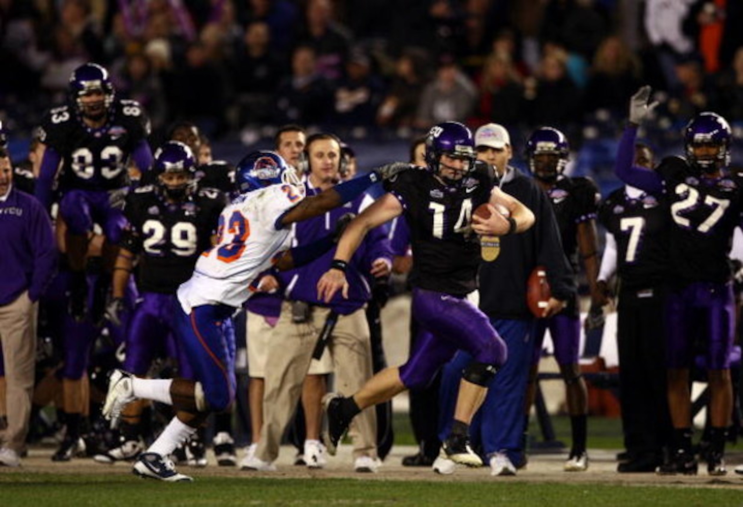 SAN DIEGO, CA - DECEMBER 23:  Quarterback Andy Dalton #14 of  TCU runs with the ball against the tackle of Safety Jeron Johnson #23 of Boise State during the San Diego County Credit Union Poinsettia Bowl at Qualcomm Stadium on December 23, 2008 in San Die