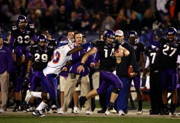 SAN DIEGO, CA - DECEMBER 23:  Quarterback Andy Dalton #14 of  TCU runs with the ball against the tackle of Safety Jeron Johnson #23 of Boise State during the San Diego County Credit Union Poinsettia Bowl at Qualcomm Stadium on December 23, 2008 in San Die