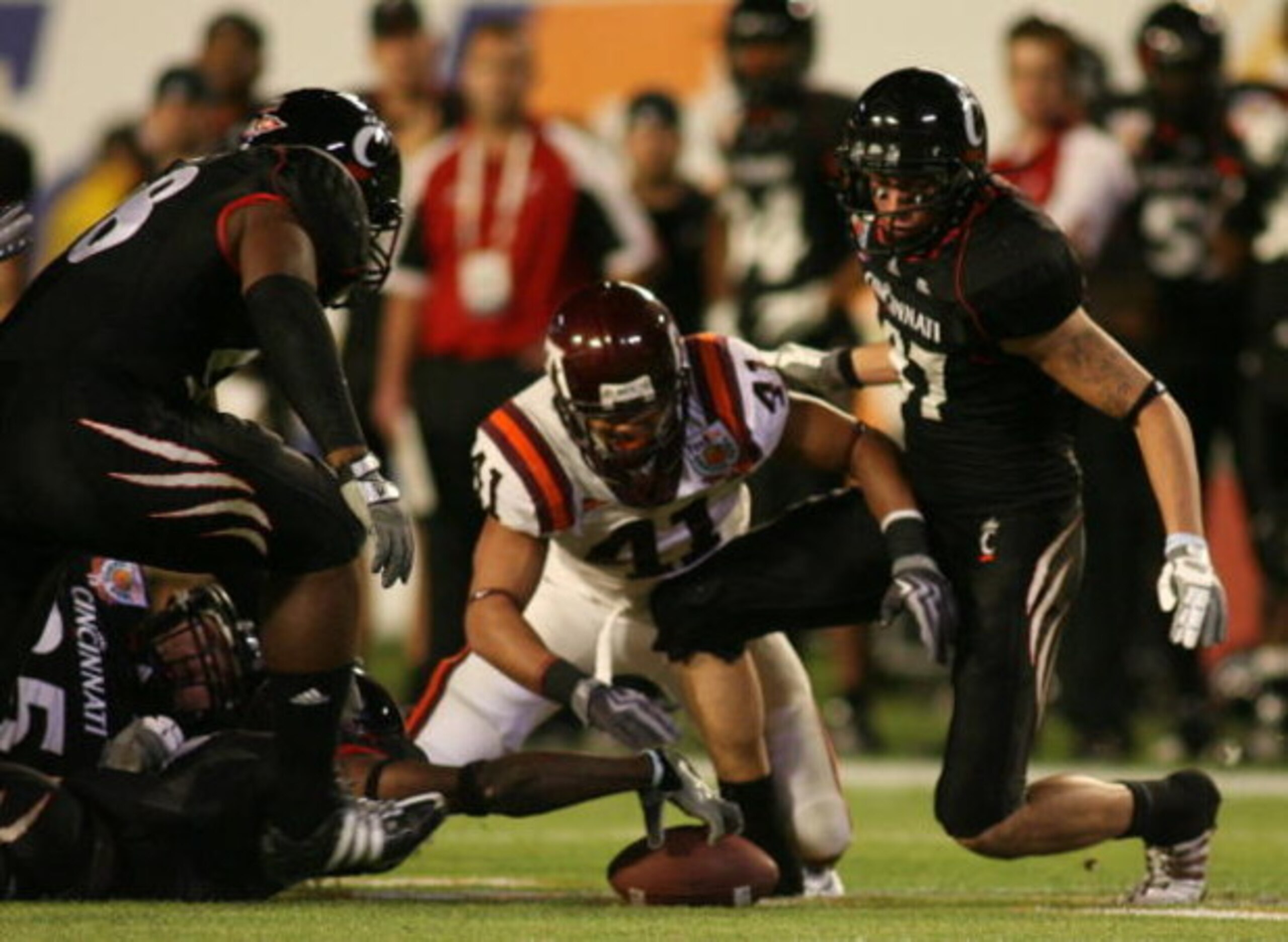 MIAMI - JANUARY 01:  Mardy Gilyard #1 of the Cincinnati Bearcats fights to recover the ball with Cam Martin #41 of the Virginia Tech Hokies after  fumbling the ball during the FedEx Orange Bowl at Dolphin Stadium on January 1, 2009 in Miami, Florida.  (Ph