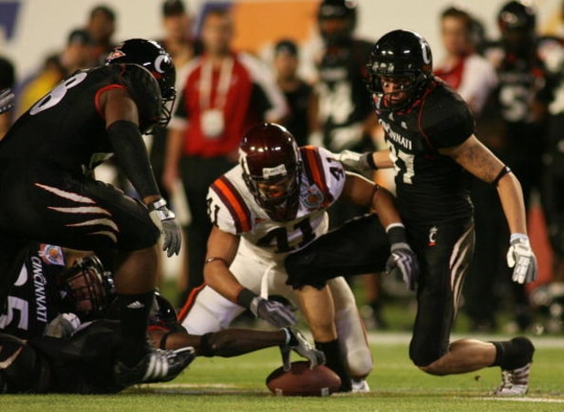 MIAMI - JANUARY 01:  Mardy Gilyard #1 of the Cincinnati Bearcats fights to recover the ball with Cam Martin #41 of the Virginia Tech Hokies after  fumbling the ball during the FedEx Orange Bowl at Dolphin Stadium on January 1, 2009 in Miami, Florida.  (Ph