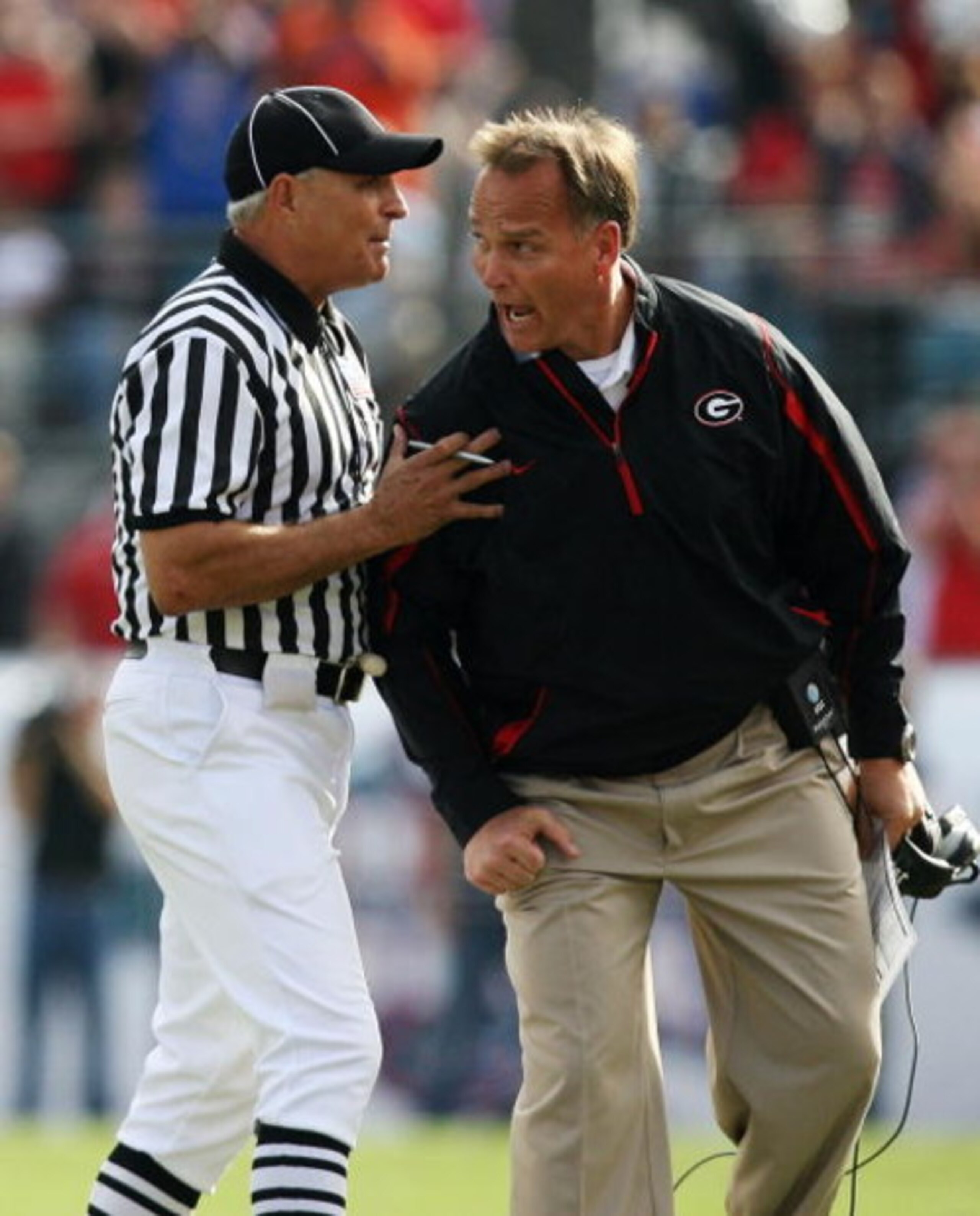 JACKSONVILLE, FL - NOVEMBER 01:  Linesman Lane Thomas holds back head coach Mark Richt of the Georgia Bulldogs after a call went against the Bulldogs while taking on the Florida Gators at Jacksonville Municipal Stadium on November 1, 2008 in Jacksonville,