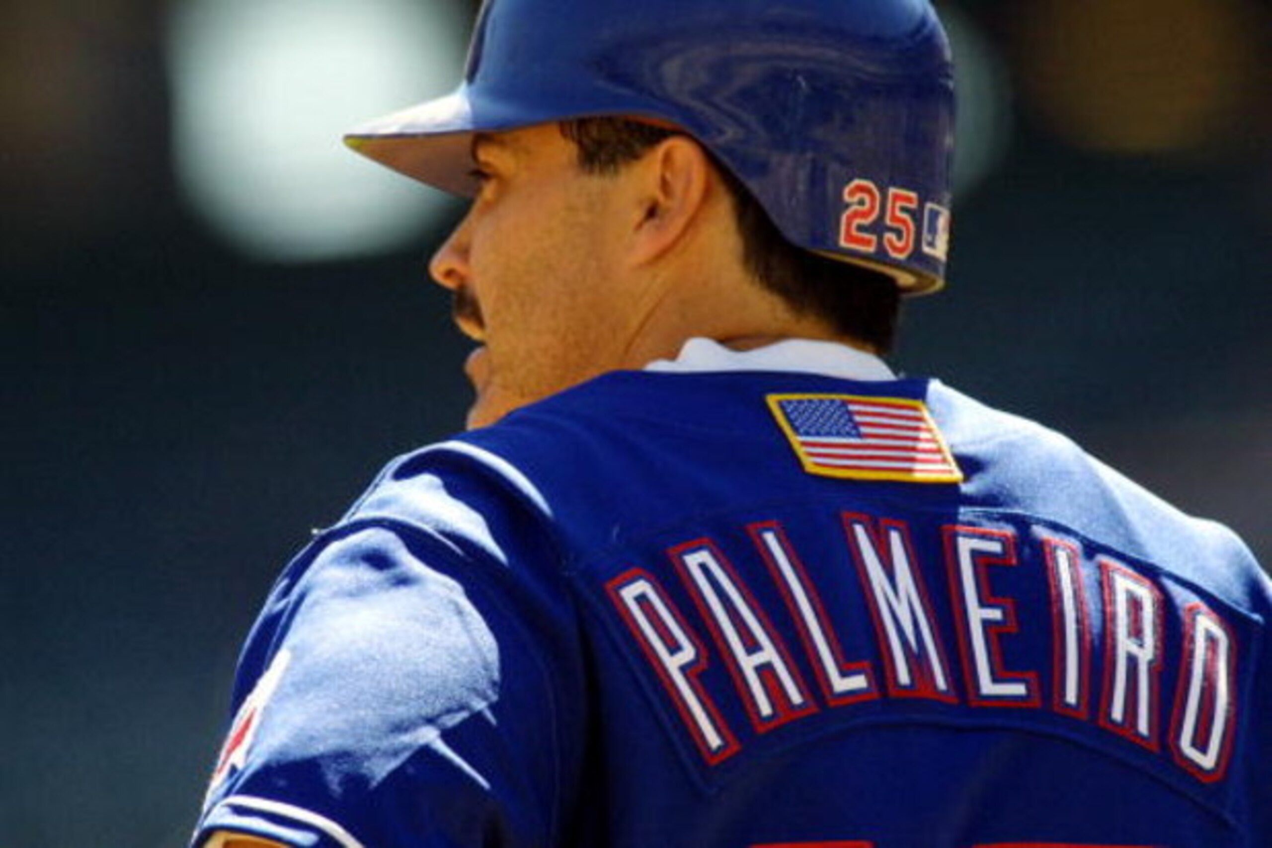 26 Sep 2001: Rafael Palmeiro #25 of the Texas Rangers looks on during the game against the Seattle Mariners at The Ballpark in Arlington, Texas. Major League Baseball is currently wearing the American flag on the back of the uniform honoring the victims 26 Sep 2001: Rafael Palmeiro #25 of the Texas Rangers looks on during the game against the Seattle Mariners at The Ballpark in Arlington, Texas. Major League Baseball is currently wearing the American flag on the back of the uniform honoring the victims