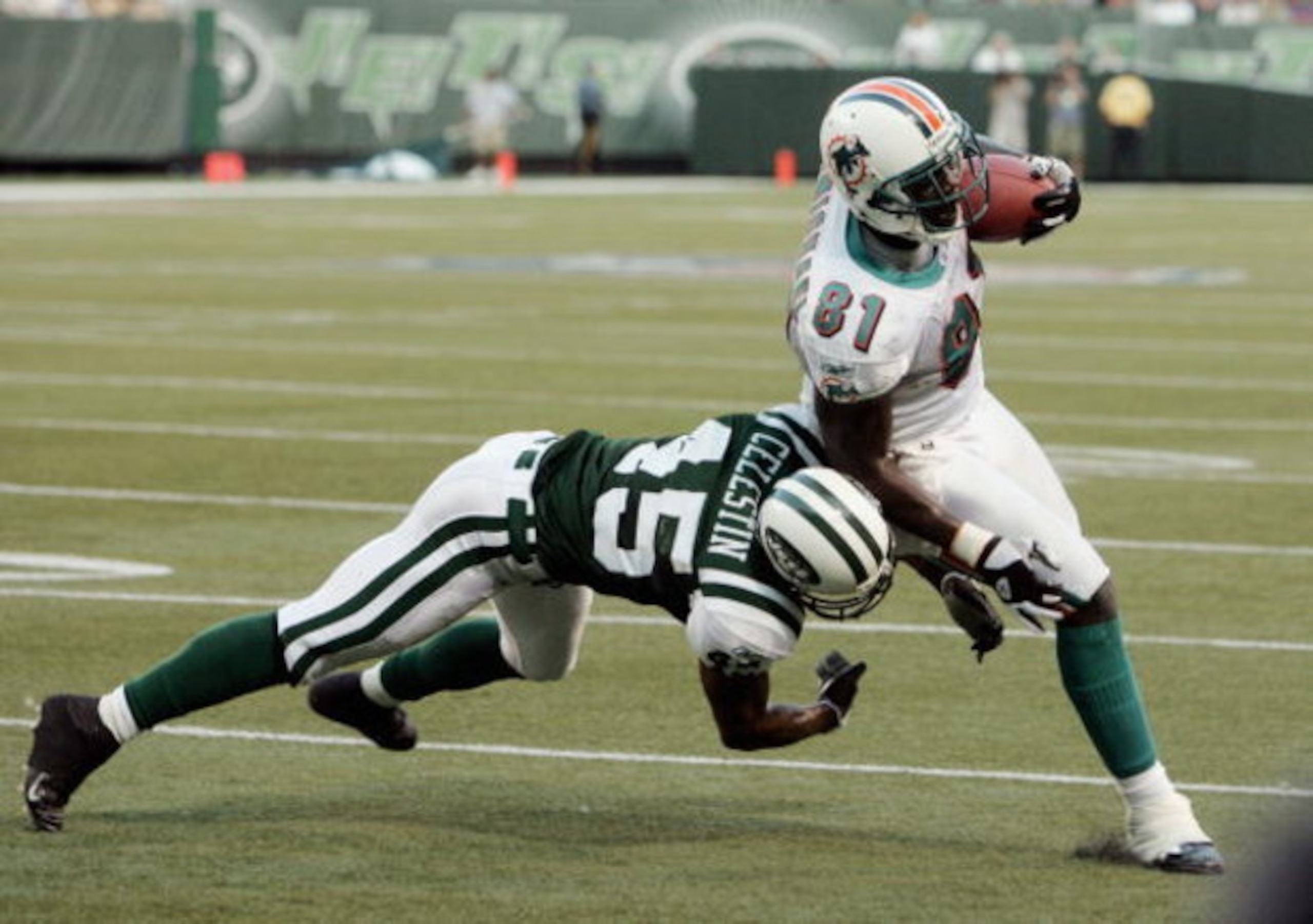 EAST RUTHERFORD, NJ - SEPTEMBER 18:  Tight end Randy McMicheal #81 of the Miami Dolphins tries to avoid safey Oliver Celestin #45 of the New York Jets during their game on September 18, 2005 at Giants Stadium in East Rutherford, New Jersey. The Jets defea