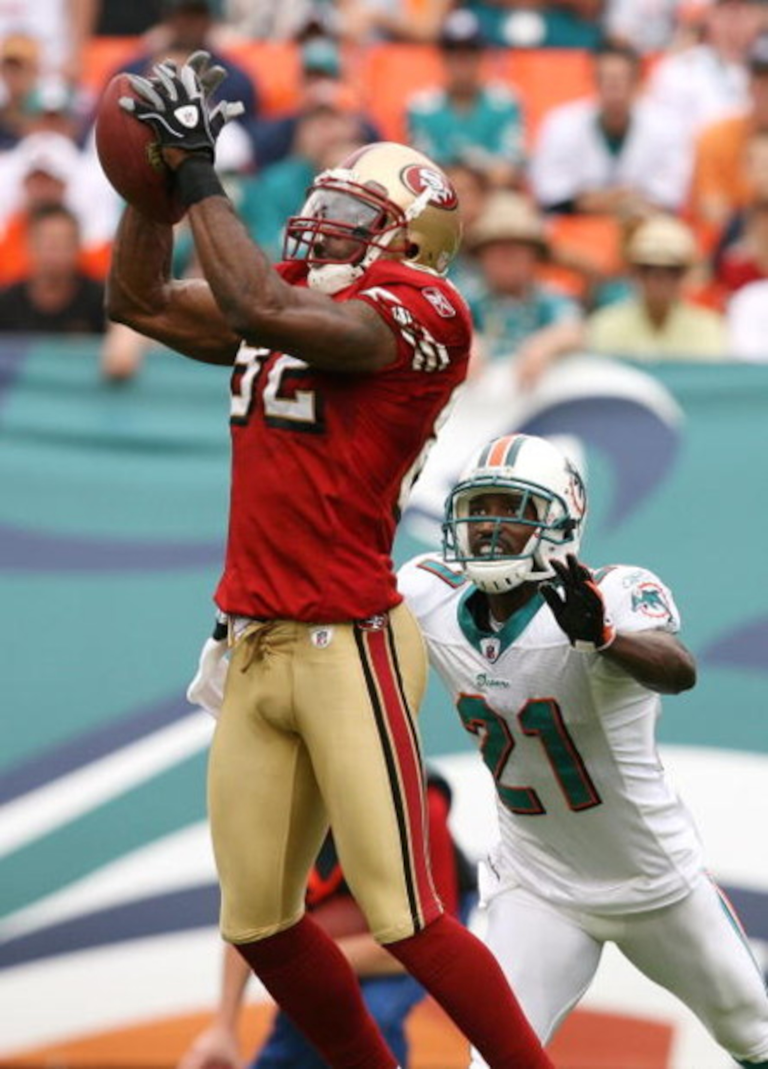 MIAMI - DECEMBER 14:  Wide receiver Bryant Johnson #82 of the San Francisco 49ers catches a pass in front of cornerback Andre Goodman #21 of the Miami Dolphins at Dolphin Stadium on December 14, 2008 in Miami, Florida. The Dolphins defeated the 49ers 14-9