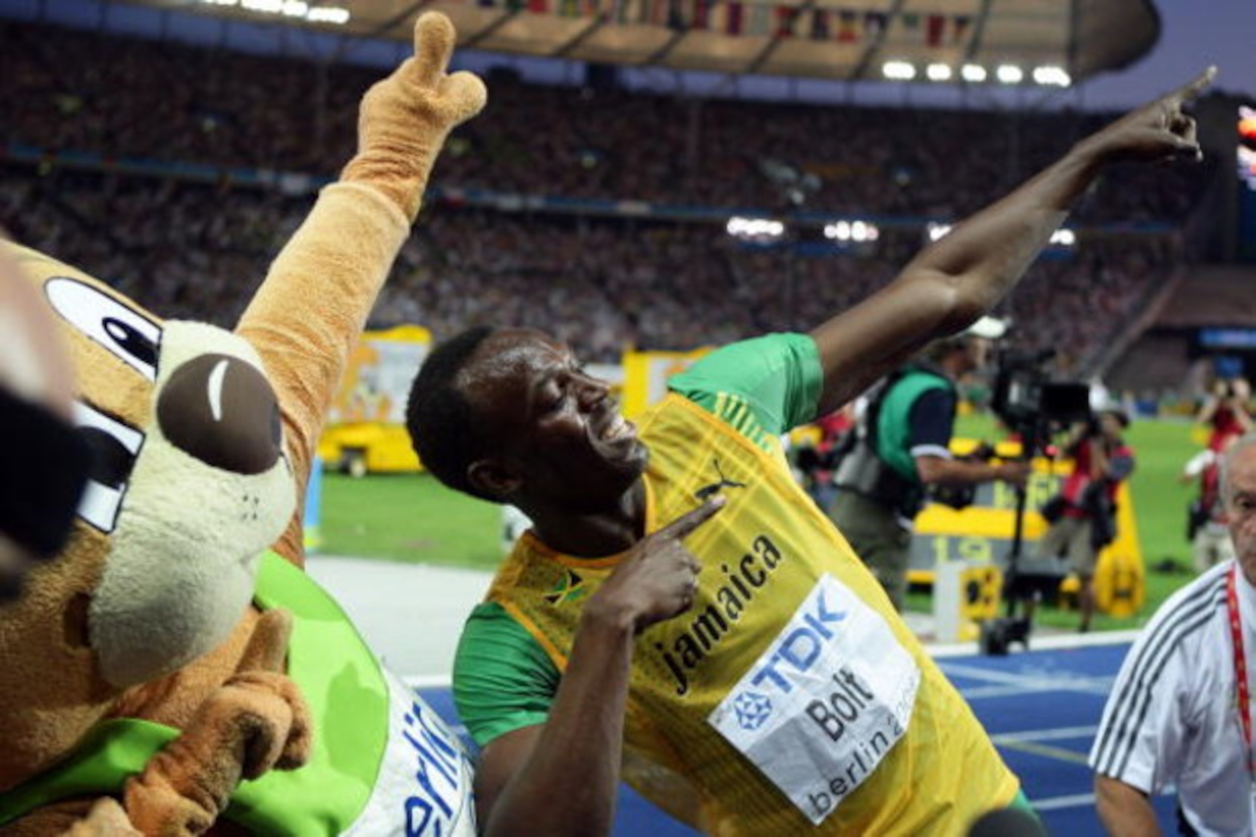 BERLIN - AUGUST 20:  Usain Bolt of Jamaica celebrates winning the gold medal in the men's 200 Metres Final during day six of the 12th IAAF World Athletics Championships at the Olympic Stadium on August 20, 2009 in Berlin, Germany.  Bolt set a new World Re