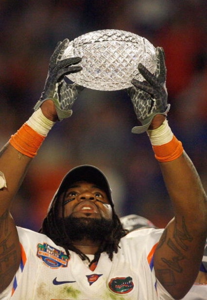 MIAMI - JANUARY 08:  Brandon Spikes #51 of the Florida Gators holds up the winning trophy after the FedEx BCS National Championship Game against the Oklahoma Sooners at Dolphin Stadium on January 8, 2009 in Miami, Florida.  (Photo by Eliot J. Schechter/Ge