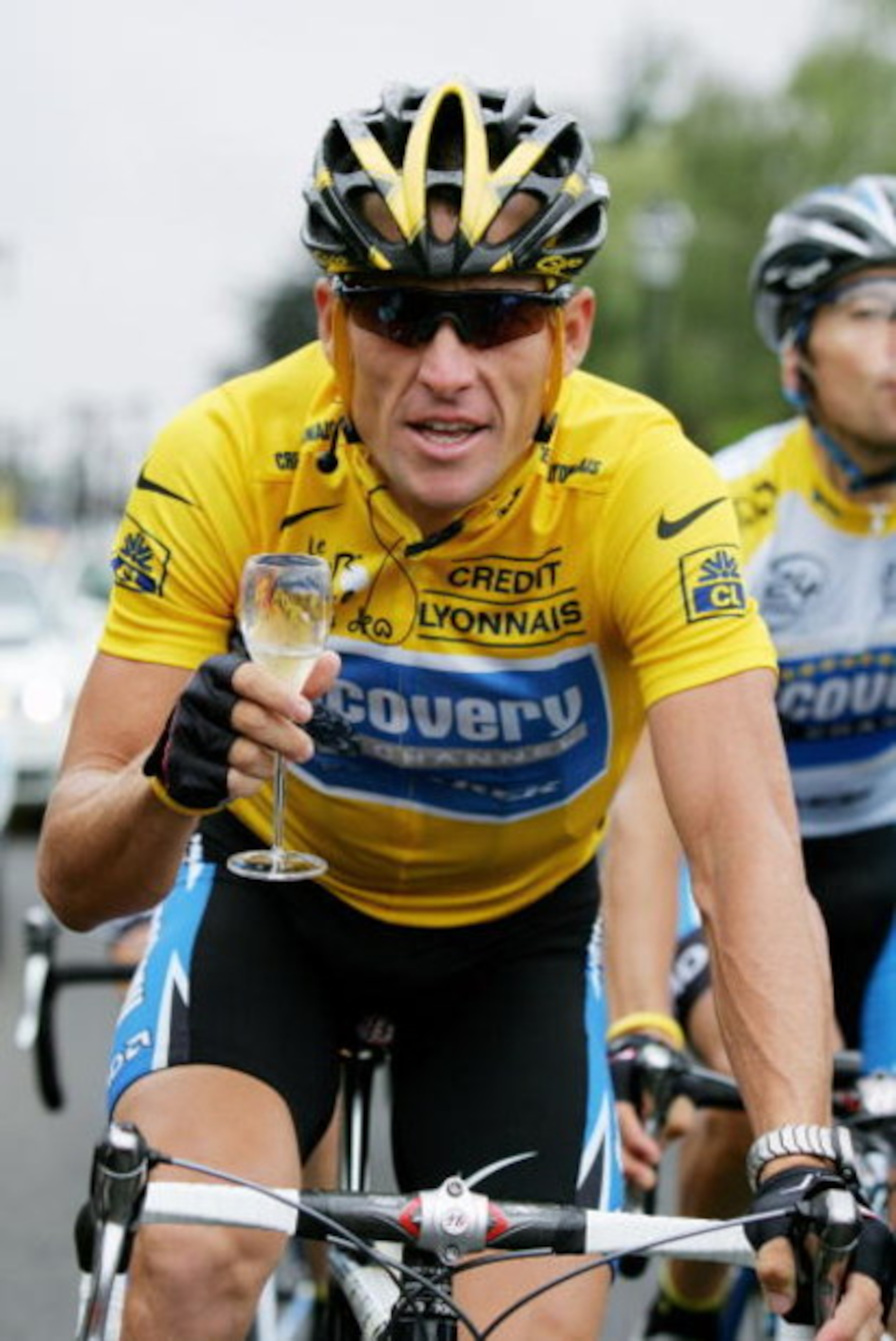 PARIS - JULY 24:  Lance Armstrong of the USA riding for the Discovery Channel team has a glass of champange on his way to winning a seventh consecutive Tour de France during Stage 21 of the Tour de France between Montereau and The Champs Elysees on July 2